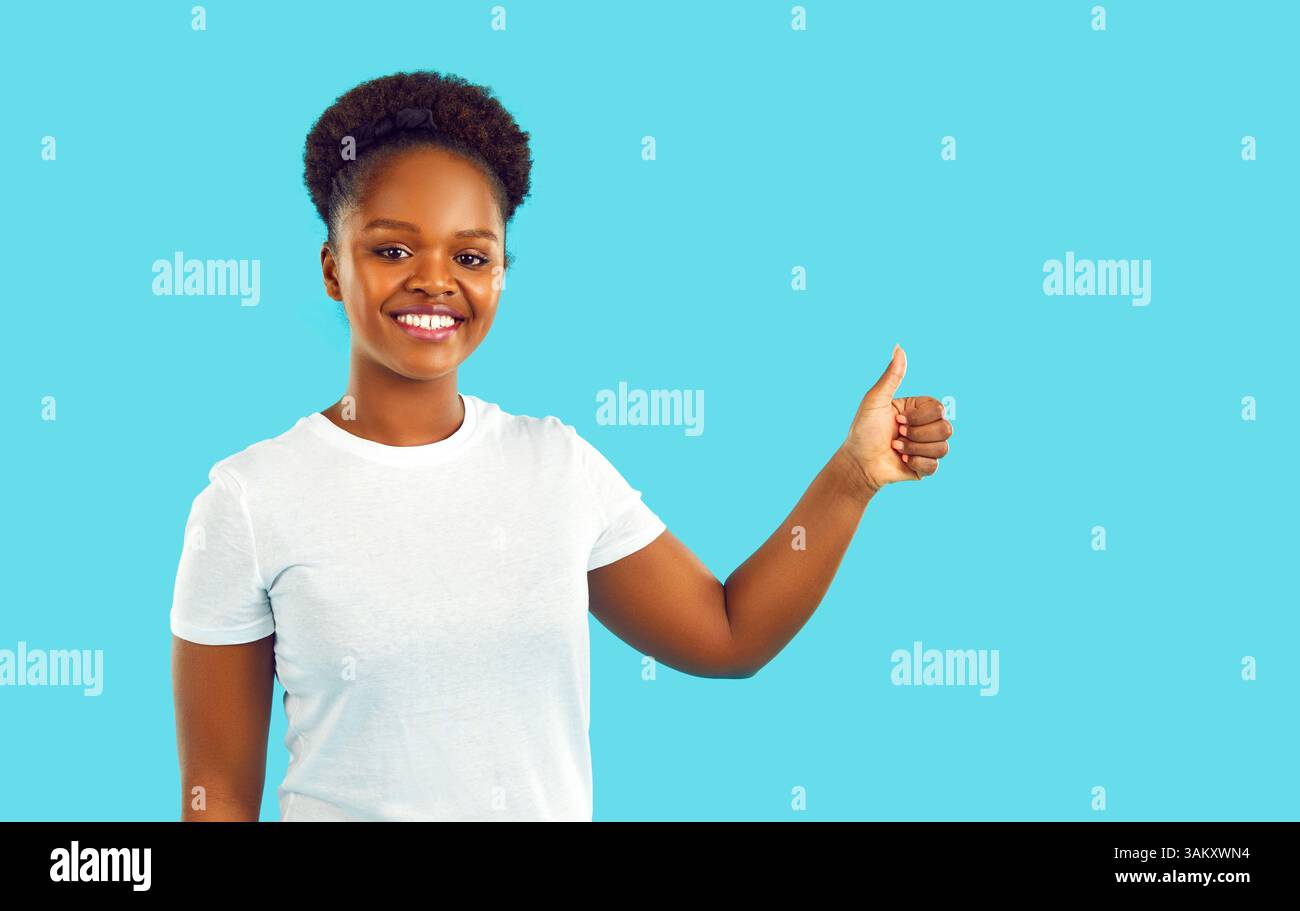 Portrait of happy young African American woman showing thumbs up ...