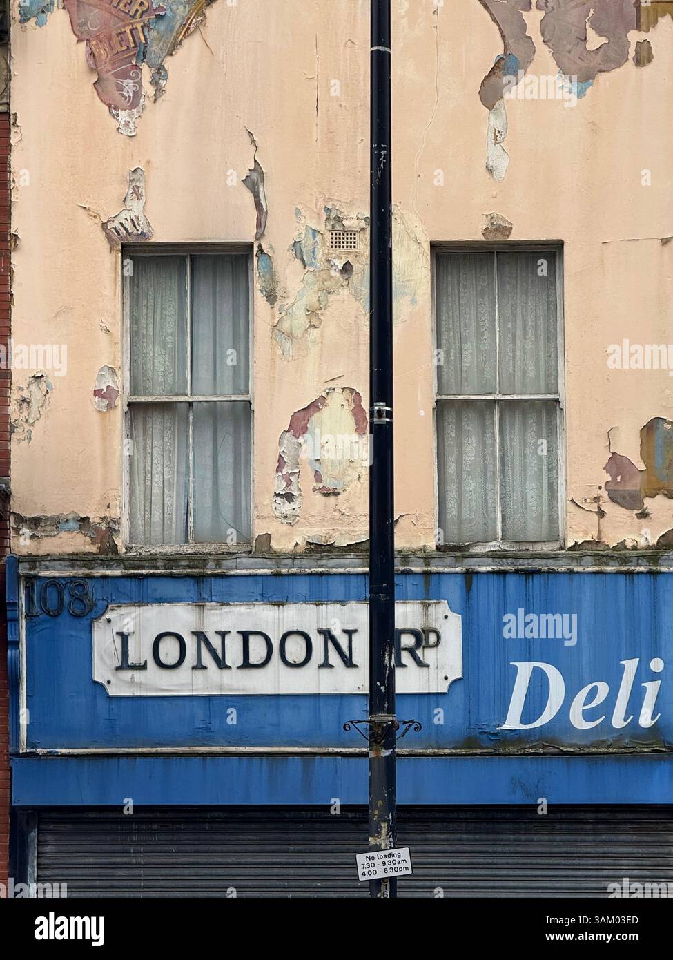 Peeling paint on deli store on London Road in Liverpool - Smartphone Captured Stock Image
