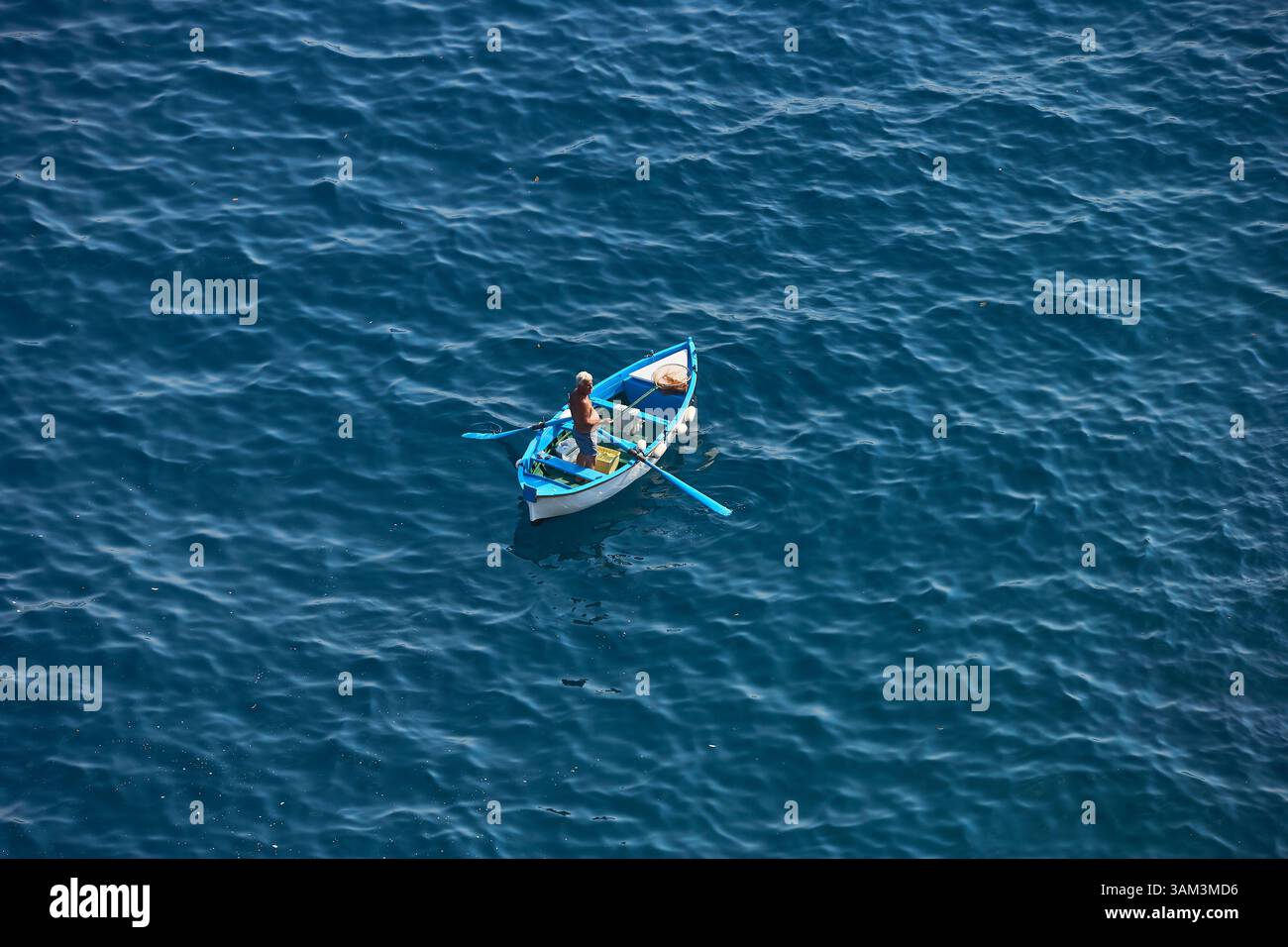 Aerial View of A Fisherman Fishing from his Boat on a Calm Blue Ocean ...