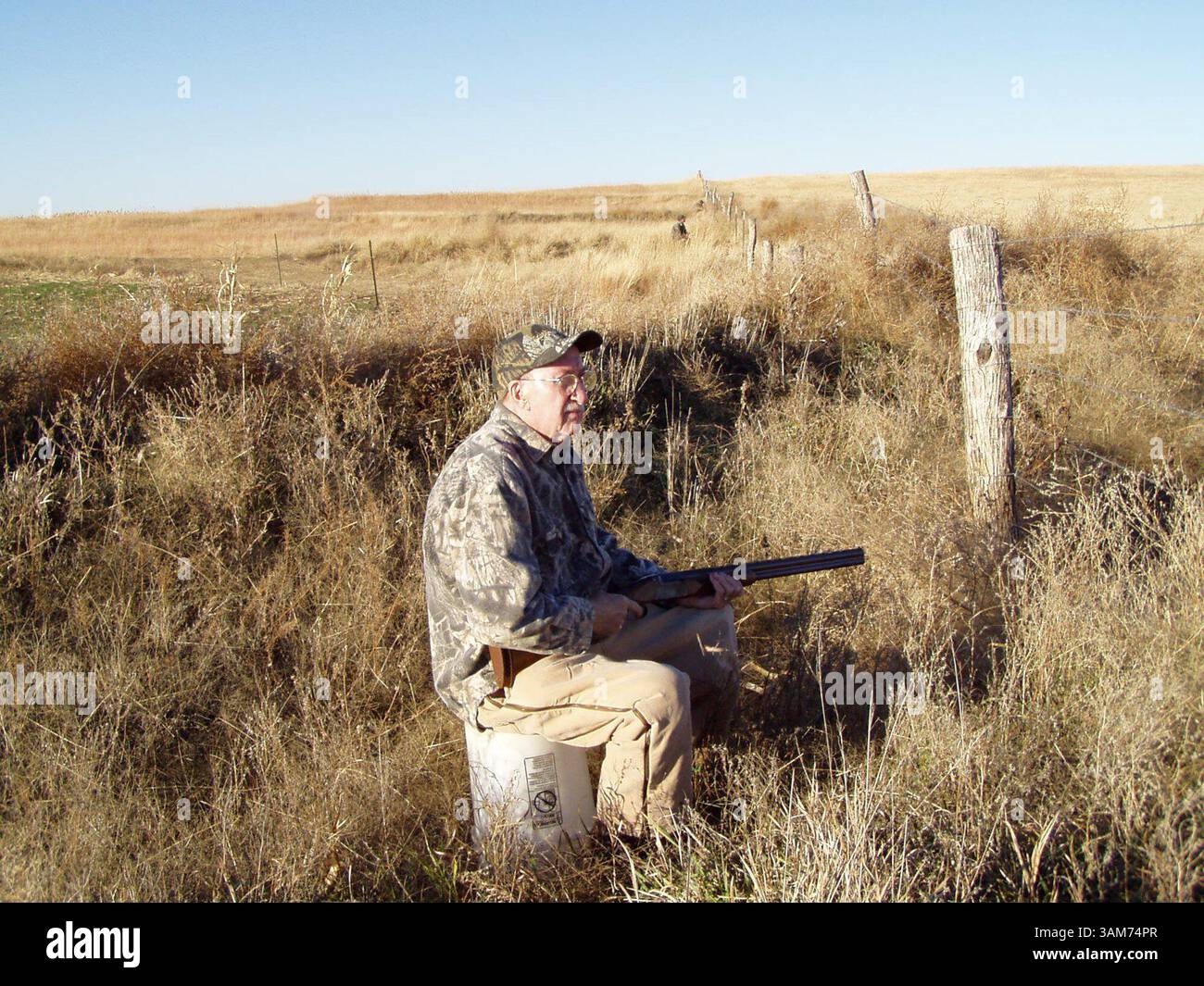Jan. 15, 2006 - U.S. - Thayne Smith, of Checotah, Oklahoma, waits along fencerow, hoping to see a flight of prairie chickens on a hunt in north-central Kansas, January 15, 2006. (Brent Frazee/Kansas City Star/KRT) (Credit Image: © Brent Frazee/mct/ZUMAPRESS.com) Stock Photo