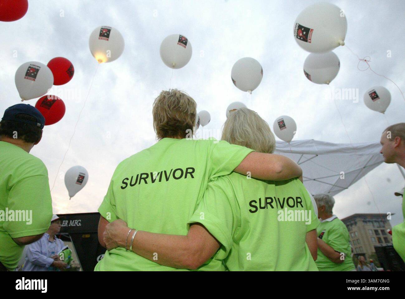 Oct. 4, 2003 - U.S. - Brandy Chappell, center left, and Shirley Dupree embrace at the start of the 5th annual Leukemia & Lymphoma Society's Light the Night Walk, October 4, 2003, in Plano, Texas. Cancer survivors must deal with fears of recurrence, treatment side effects, long-term consequences and other challenges. (Gary Payne/Dallas Morning News/KRT) (Credit Image: © Gary Payne/mct/ZUMAPRESS.com) Stock Photo