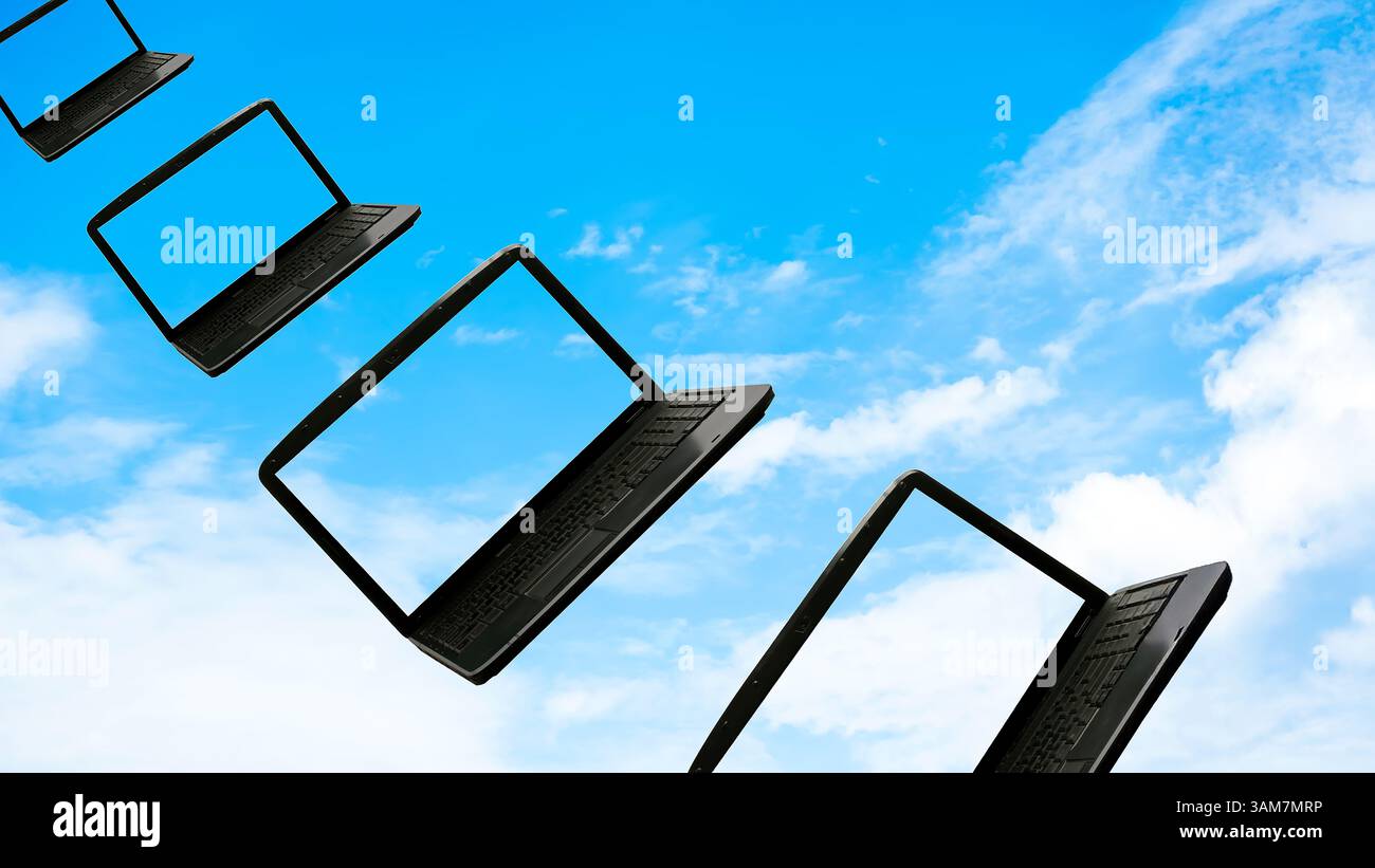 Laptops flying along the blue sky, concept cloudcomputing Stock Photo