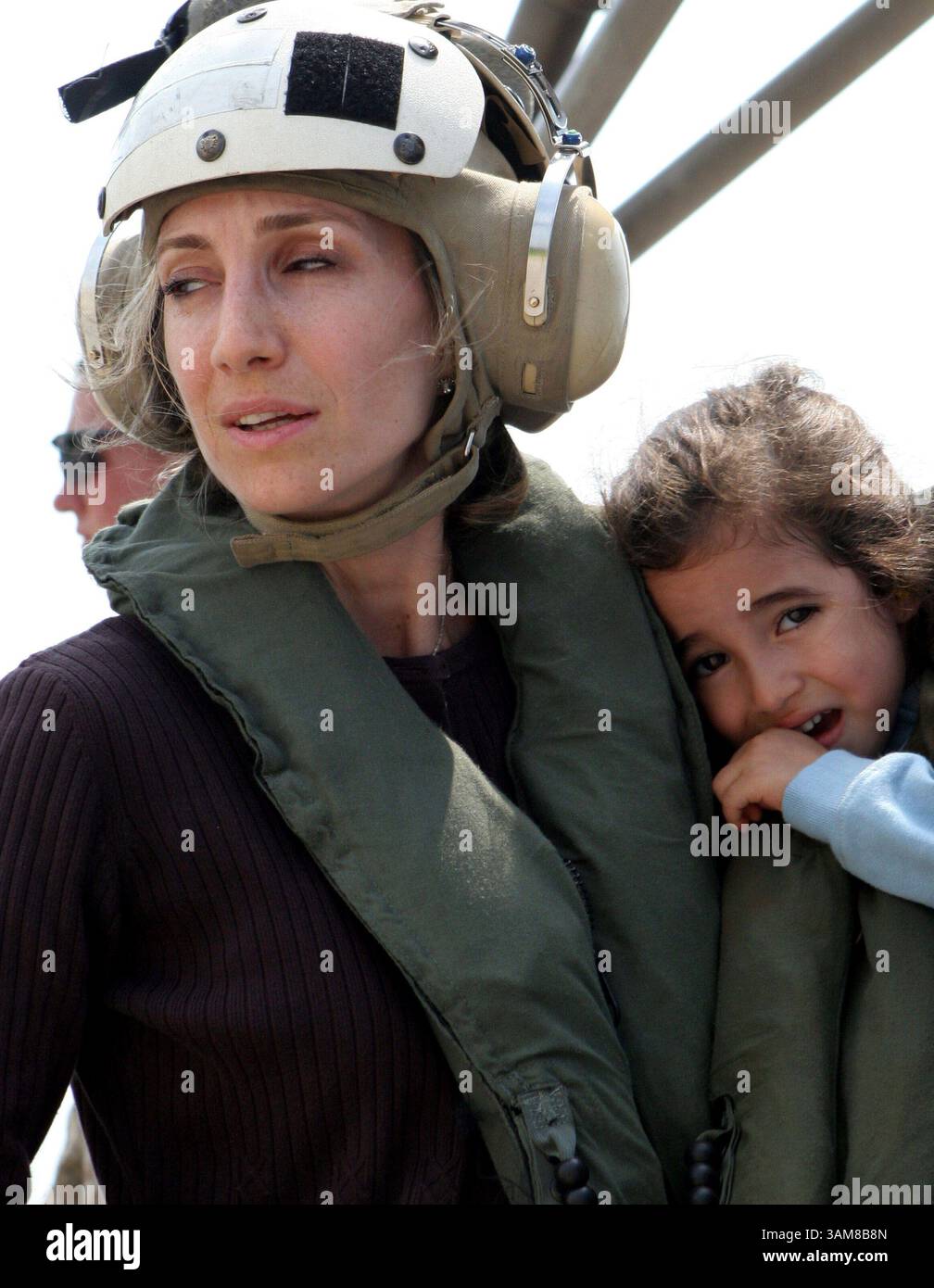 July 19, 2006 - U.S. - A U.S. citizen holds a child as they wait to board a U.S. Marine Corps CH-53 Super Stallion helicopter at the U.S. Embassy in Beirut, Lebanon. At the request of the U.S. Ambassador to Lebanon and at the direction of the Secretary of Defense, the United States Central Command and 24th Marine Expeditionary Unit are assisting with the departure of U.S. citizens from Lebanon. (James H. Frank/US Navy News Photo/MCT) (Credit Image: © James H. Frank/mct/ZUMAPRESS.com) Stock Photo