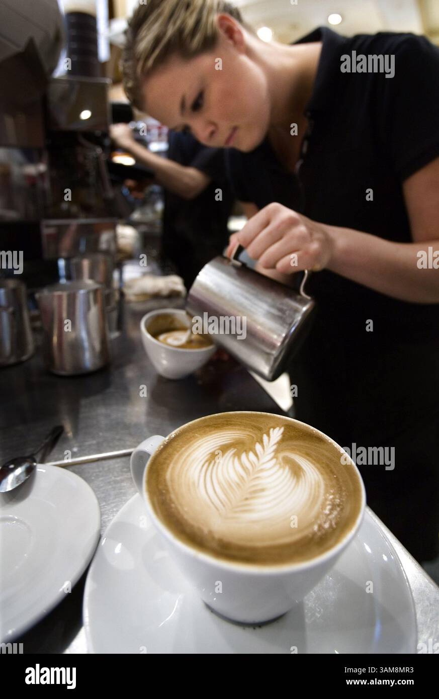 Sept. 25, 2006 - U.S. - Lindsay Parker (right), one of the managers of Caffe Artigiano and last year's National Latte Art Champion for Canada, works her magic behind the the bar in Vancouver, British Columbia. (Bill Hogan/Chicago Tribune/MCT) (Credit Image: © Bill Hogan/mct/ZUMAPRESS.com) Stock Photo