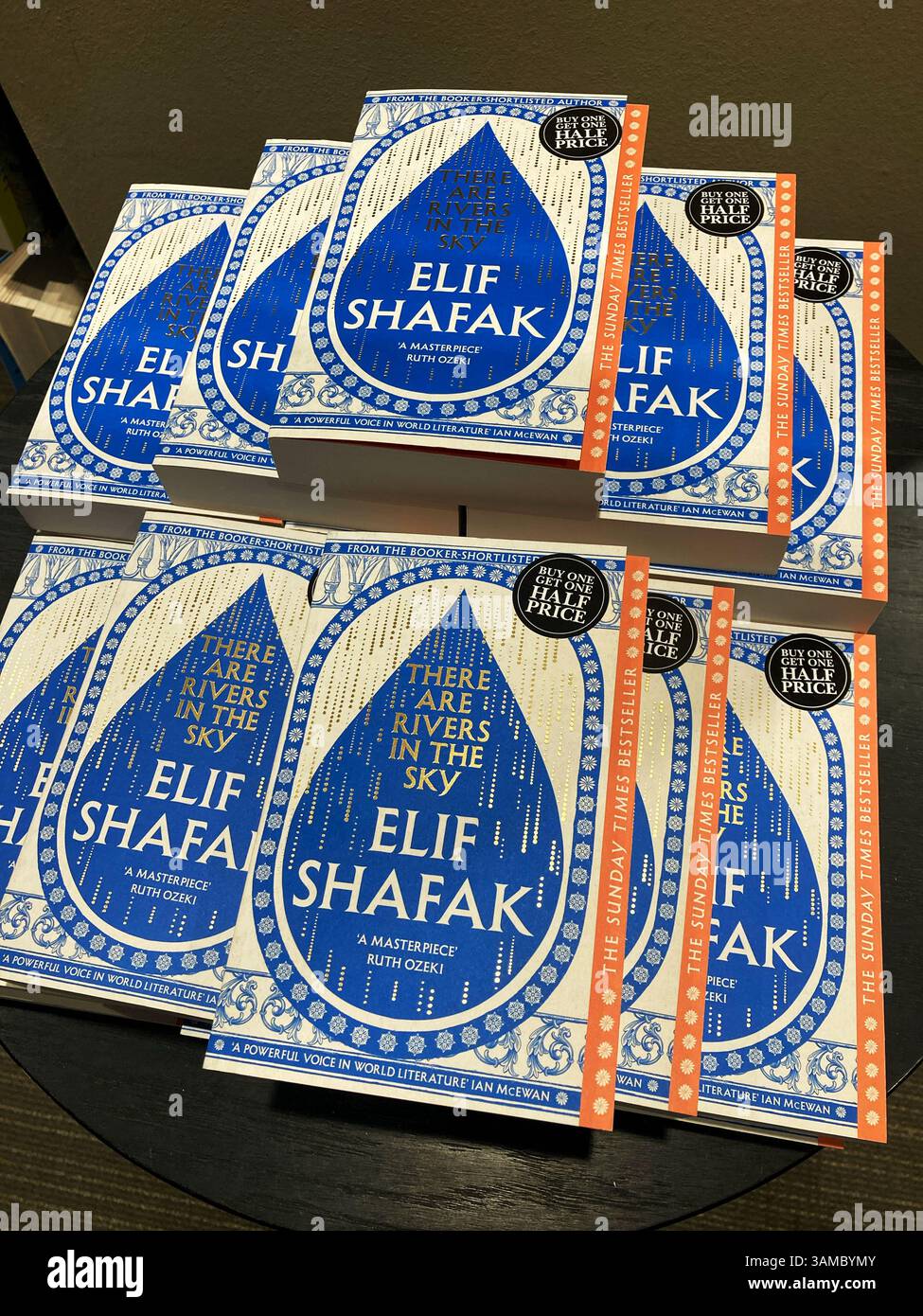 There are Rivers in the Sky, a novel by Elif Shafak for sale at the bookstore with a buy one get one half price offer - Smartphone Captured Stock Image