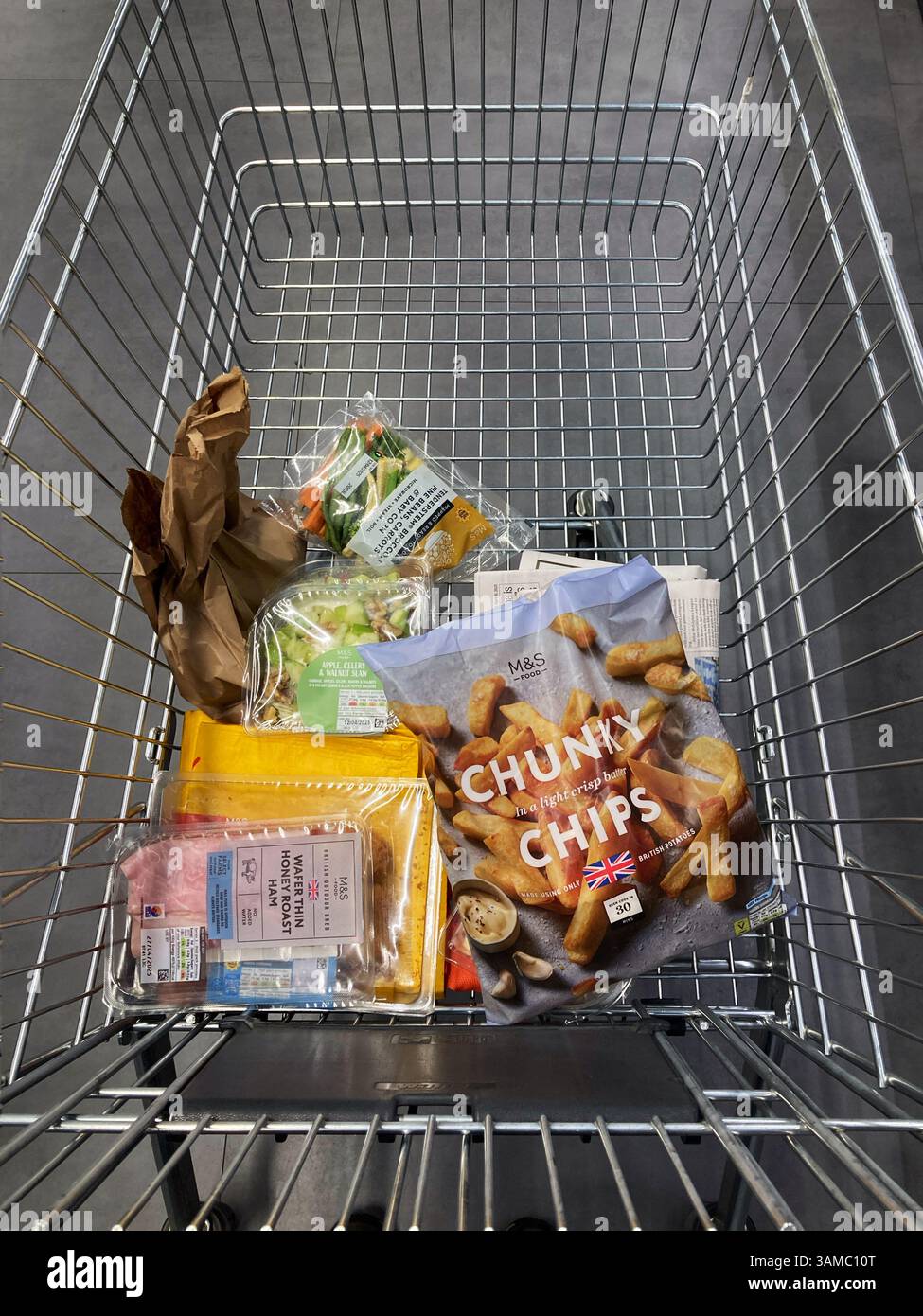 Shopping trolley filling up with groceries in a Marks and Spencer food hall - Smartphone Captured Stock Image