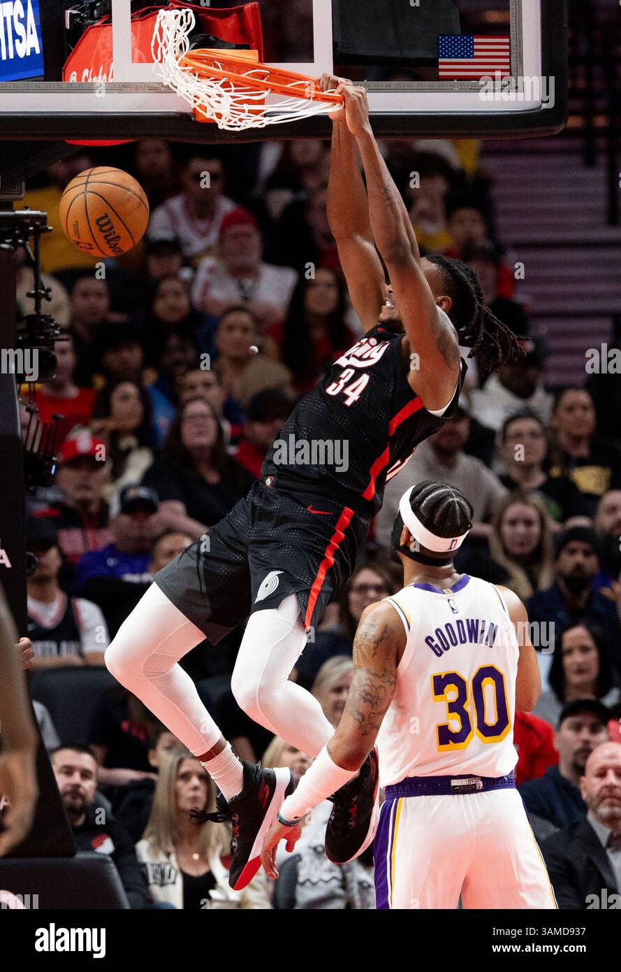 Portland Trail Blazers forward Jabari Walker, middle, dunks the ball ...