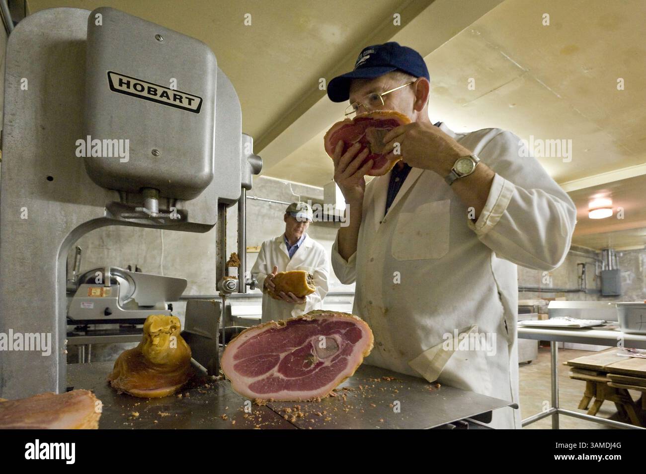 Oct. 8, 2008 - West Jefferson, NC, USA - Byron Jordan smells a ham, January 22, 2008 at the ham house in West Jefferson, North Carolina. A bad ham reveals itself by a sour smell. Jordan says, ''You treat two hams the identical same way. You salt them the same, you hang them side by side, and one will cure out and one won't.'' (Gary O'Brien/Charlotte Observer/MCT) (Credit Image: © Gary O'Brien/MCT/ZUMAPRESS.com) Stock Photo