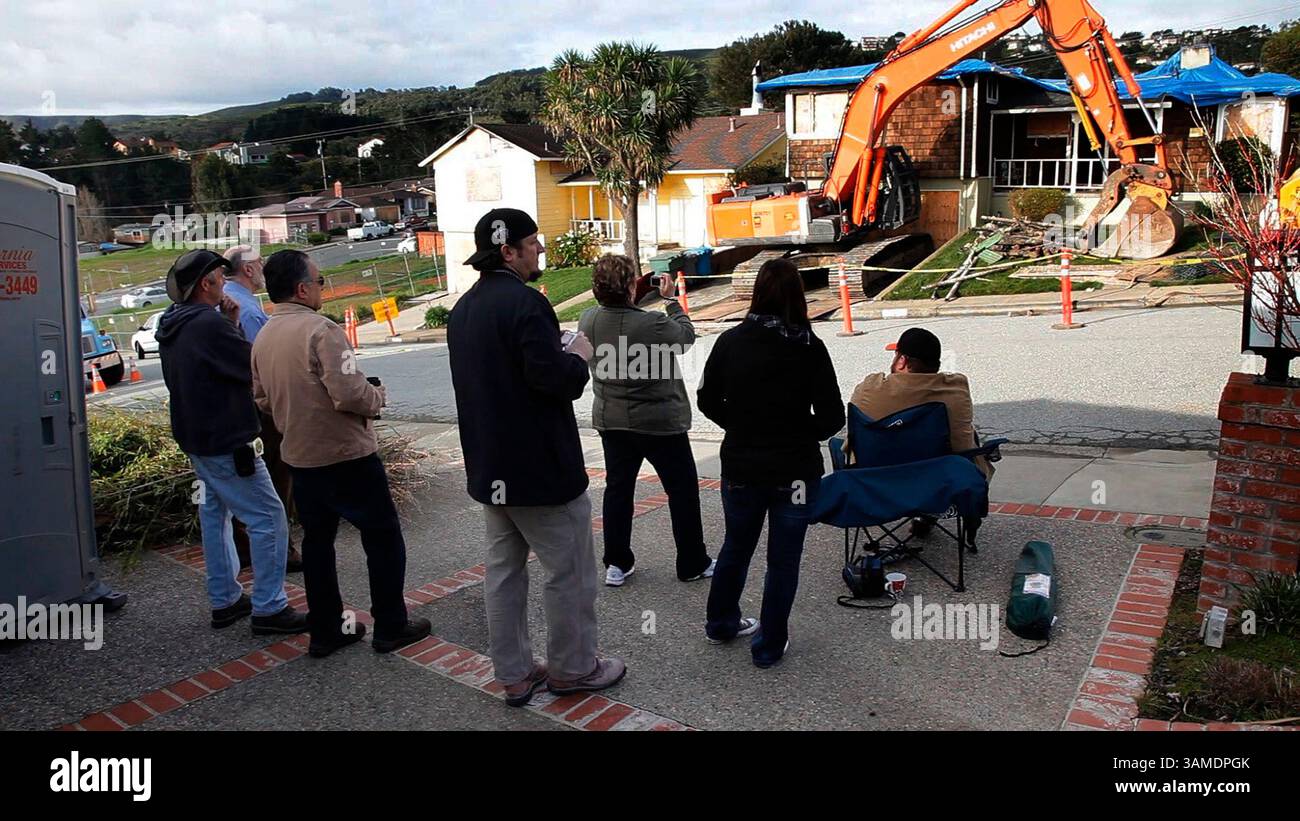 March 22, 2011 - San Bruno, CA, USA - Members of the Vasquez family watch as workers demolish the family home in San Bruno, California, on March 22, 2011. The home was damaged beyond repair in a natural gas pipeline explosion. The family plans on rebuilding. (Gary Reyes/San Jose Mercury News/MCT) (Credit Image: © Gary Reyes/MCT/ZUMAPRESS.com) Stock Photo
