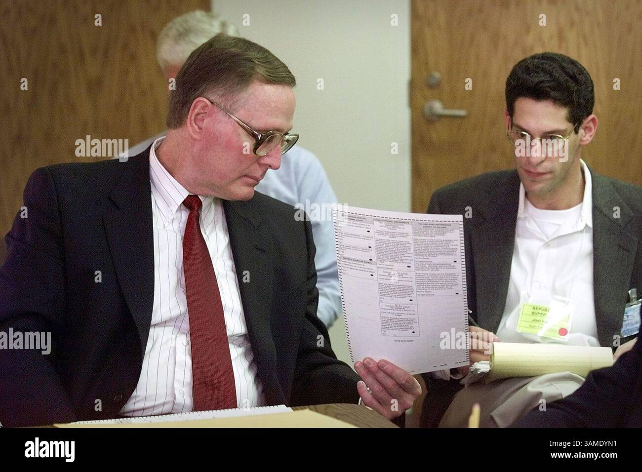 Nov. 13, 2000 - STAMP, U.S. - KRT US NEWS STORY SLUGGED: ELN-PRESIDENT KRT PHOTOGRAPH BY DAVID BERGMAN/MIAMI HERALD (FORT LAUDERDALE OUT) (November 13) DELAND, FLORIDA-- Judge Michael McDermott, left, shows a questionable ballot to Republican Supervisor Joel Kaplan as the canvassing committee reviews ballots to determine the intent of the voter Monday November 13 at the Thomas C. Kelly Administration Center near the Volusia County Courthouse in Deland, Florida.  A federal judge on Monday rejected a request by the Bush campaign for an injunction to halt hand counting of ballots in four Florida Stock Photo