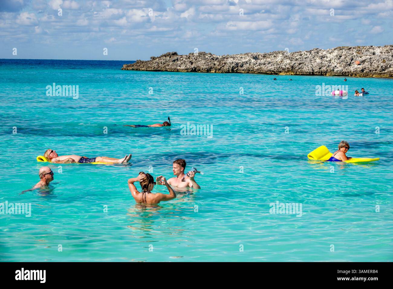 Great Stirrup Cay The Bahamas,passengers swimming,people floating,relaxing in water,snorkeling,tropical beach scene,clear turquoise sea,private island Stock Photo
