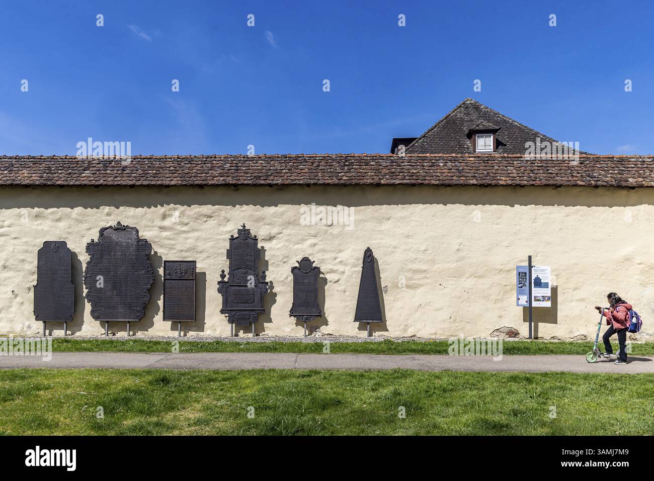 Epithaphs, cast-iron grave inscriptions on the monastery wall in Koenigsbronn. The elaborately crafted epithaphs of the master smelters and abbots of Stock Photo