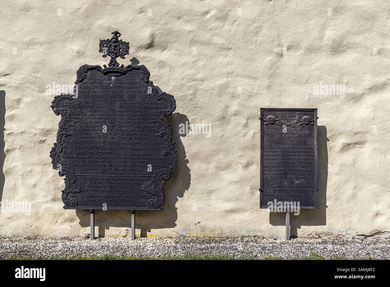 Epithaphs, cast-iron grave inscriptions on the monastery wall in Koenigsbronn. The elaborately crafted epithaphs of the master smelters and abbots of Stock Photo