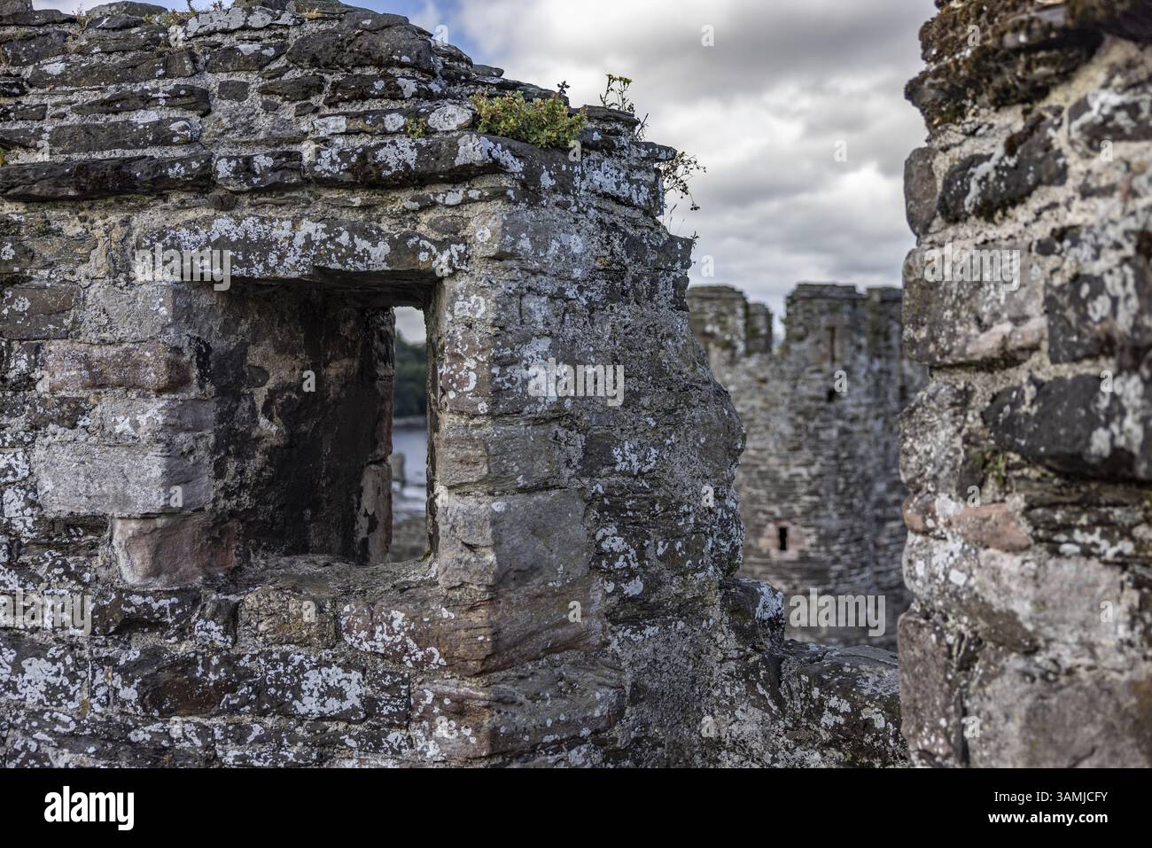 Conwy Castle, view through a weathered opening in the castle wall to ...