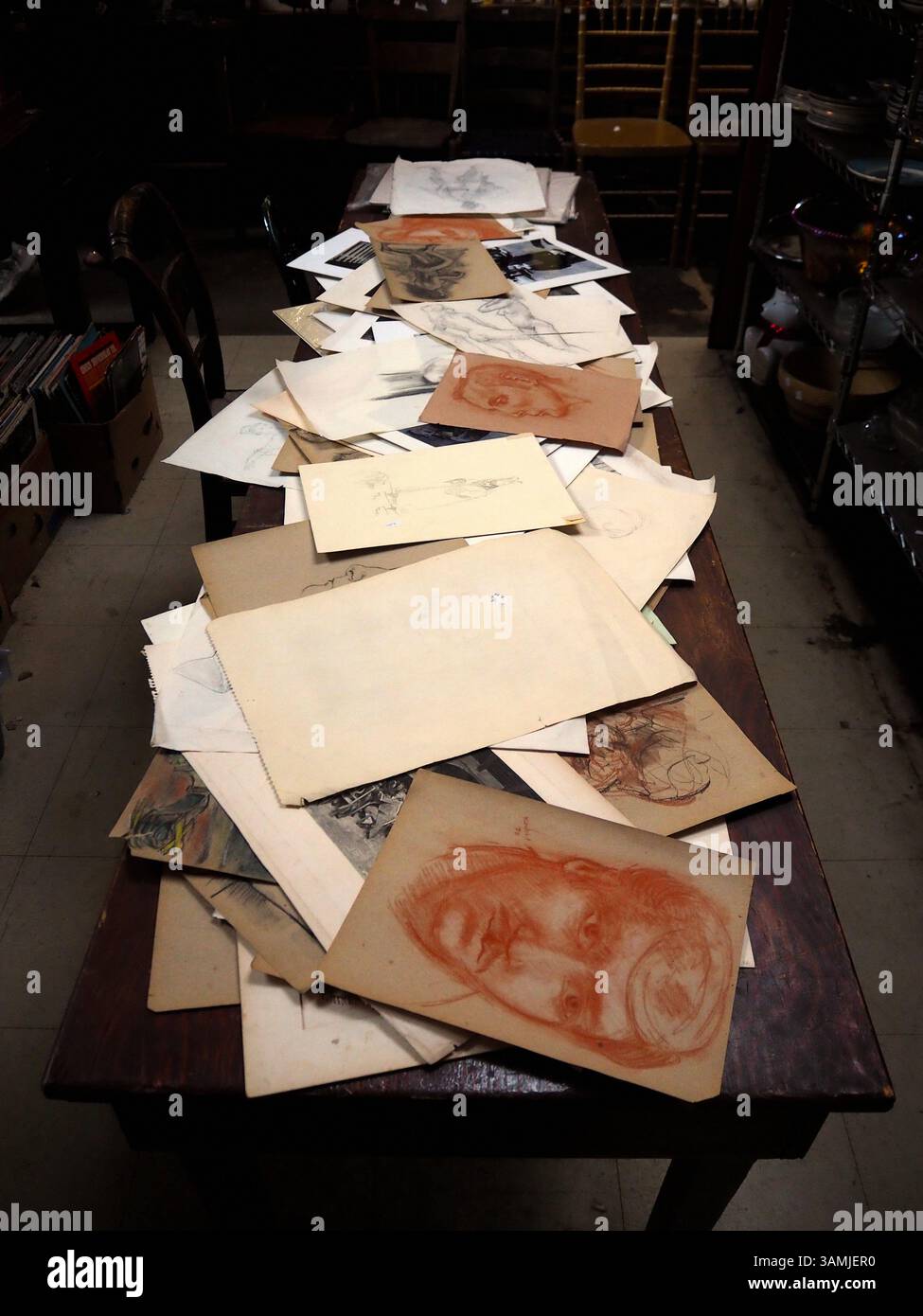 Forgotten faces and paper memories on the table, Brooklyn, New York Stock Photo