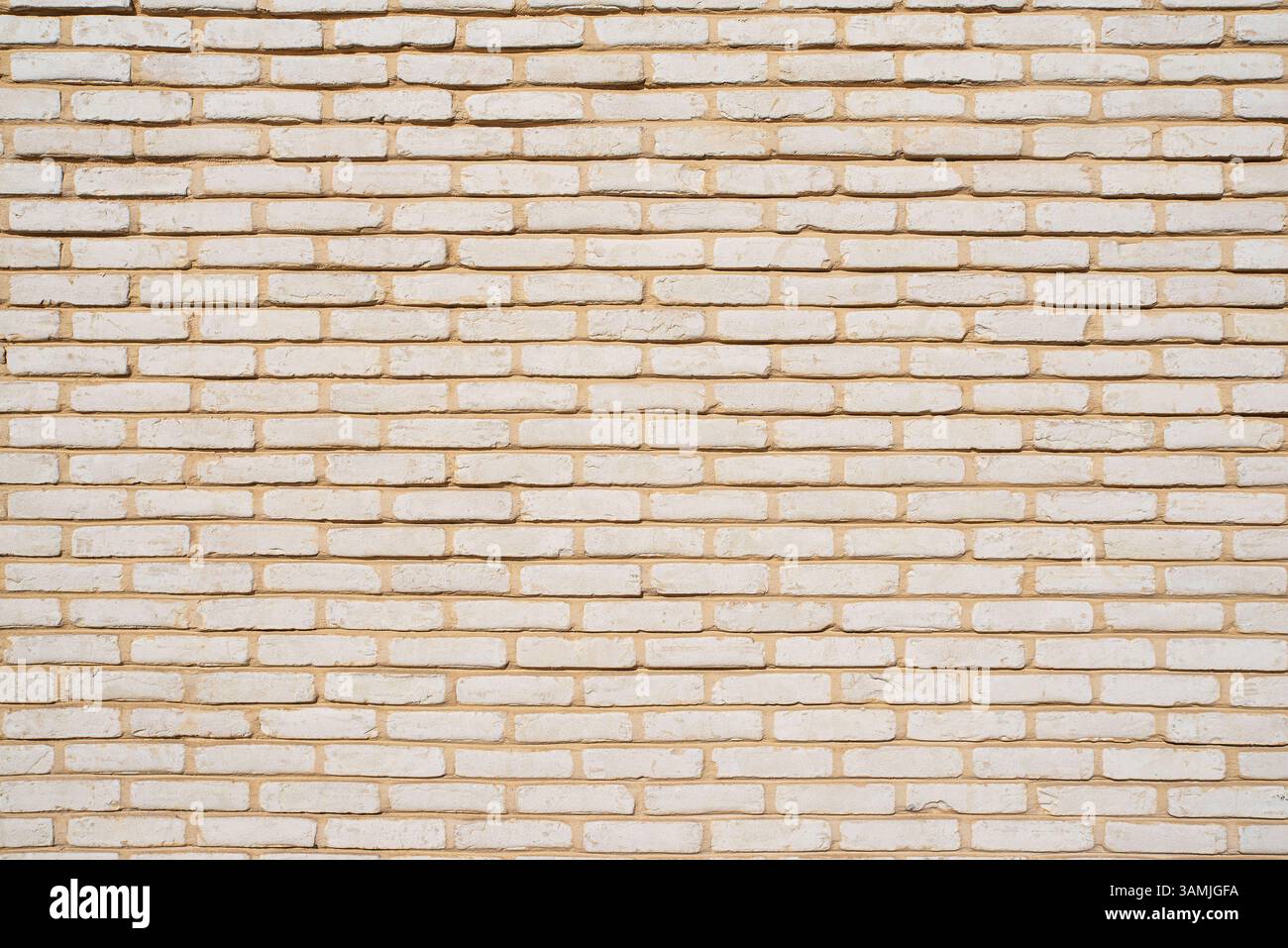 Texture of a wall of small beige bricks Stock Photo