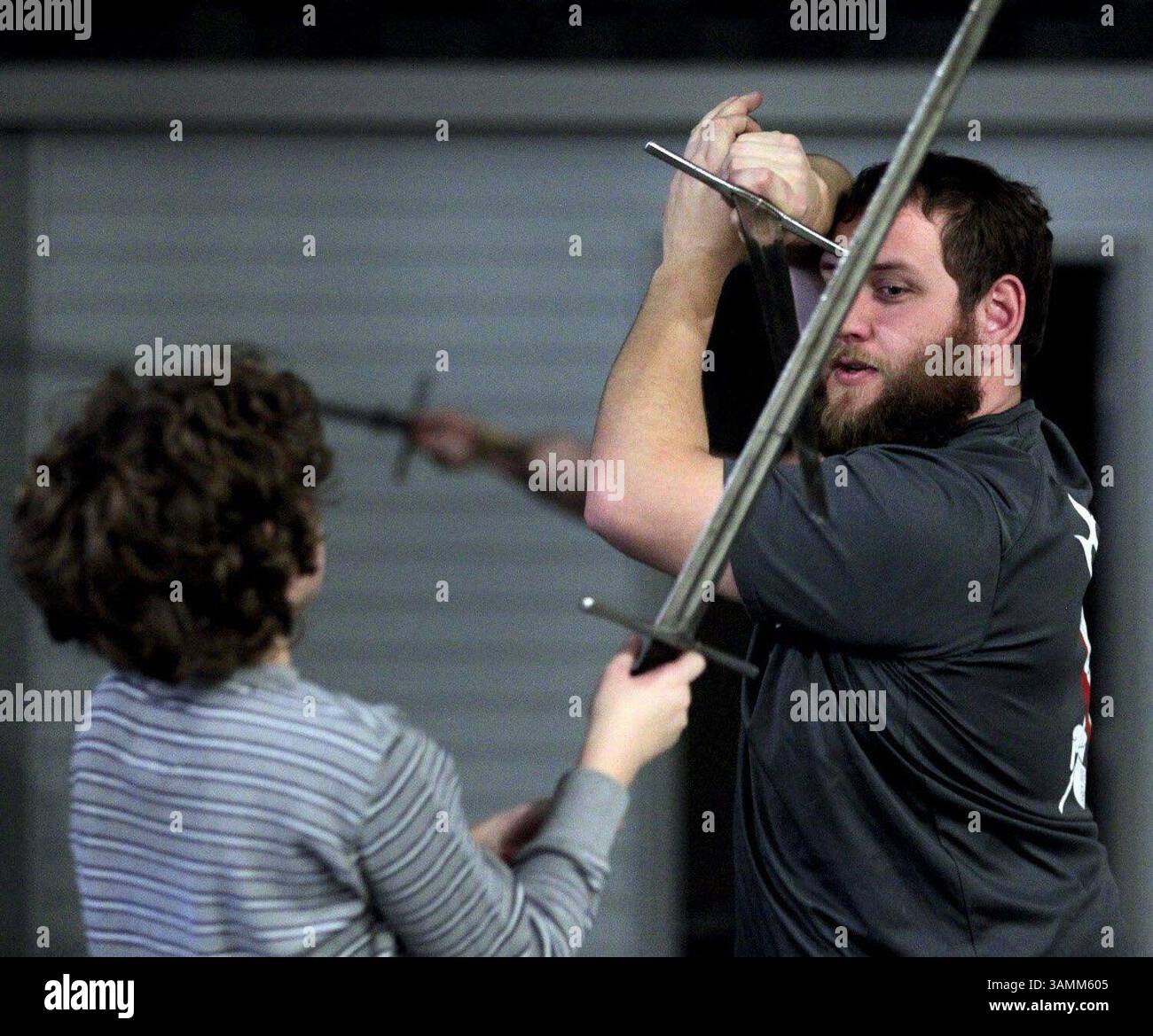 Dec. 31, 2013 - Jackson, WI, USA - Jeremiah Backhuas, right, works with Elan Graupe, 12, at Sword Camp in Jackson, Wisc. The camp teaches basics of historical fencing and sword play. (Credit Image: © Kristyna Wentz-Graff/MCT/ZUMAPRESS.com) Stock Photo