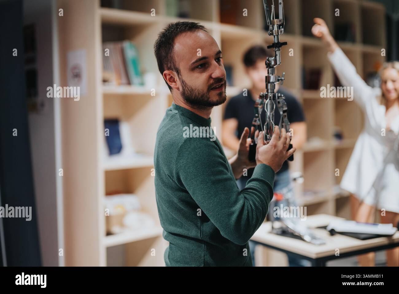 Man engaging with technology in a collaborative and creative workspace environment Stock Photo