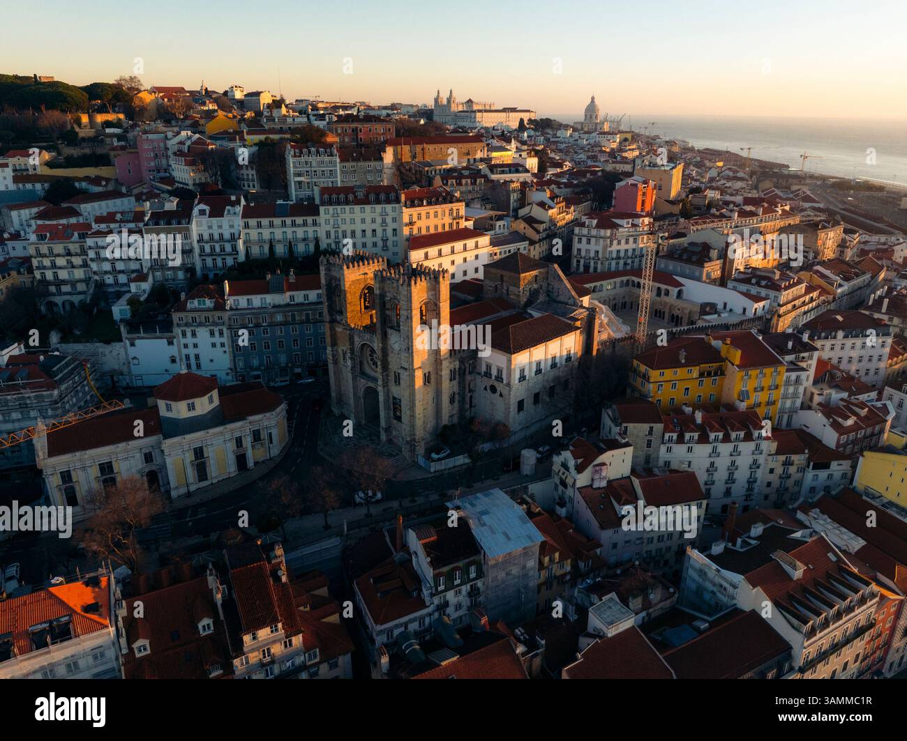 Aerial view of historic Lisbon Cathedral surrounded by vibrant red ...