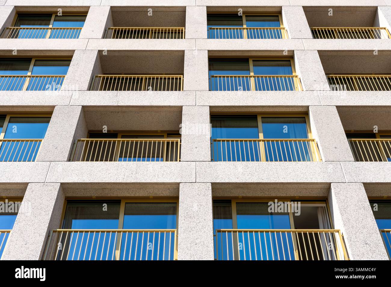 Frontal view of modern apartment building in Poland with yellow balcony ...