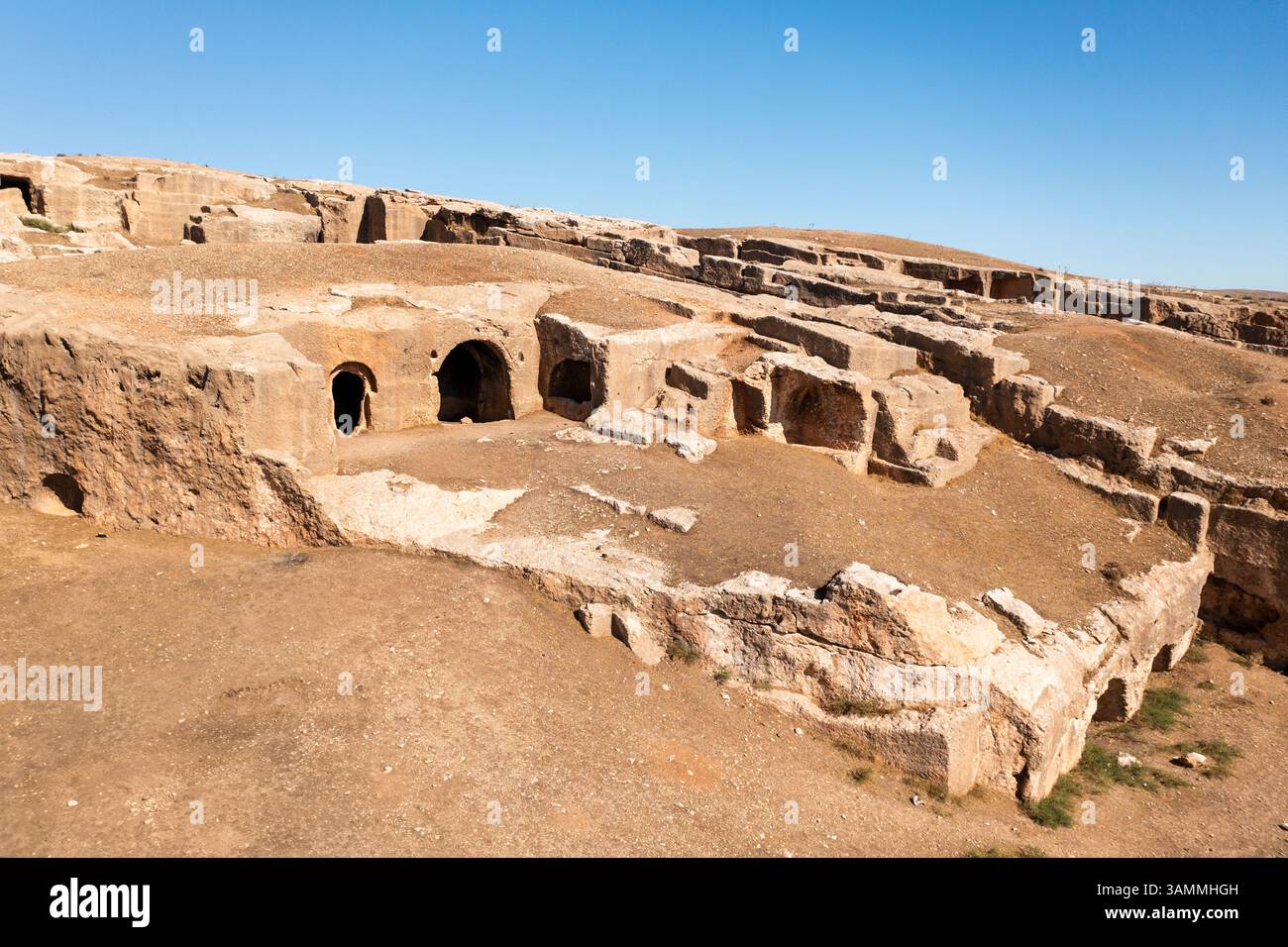 Aerial View Of Ancient Ruins And Rugged Rock Formations In A Barren aerial-view-of-ancient-ruins-and-rugged-rock-formations-in-a-barren