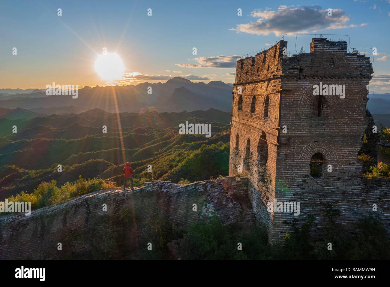 Aerial view of the majestic Jinshanling old Great Wall amidst scenic mountains at sunset, Chengde, China. Stock Photo