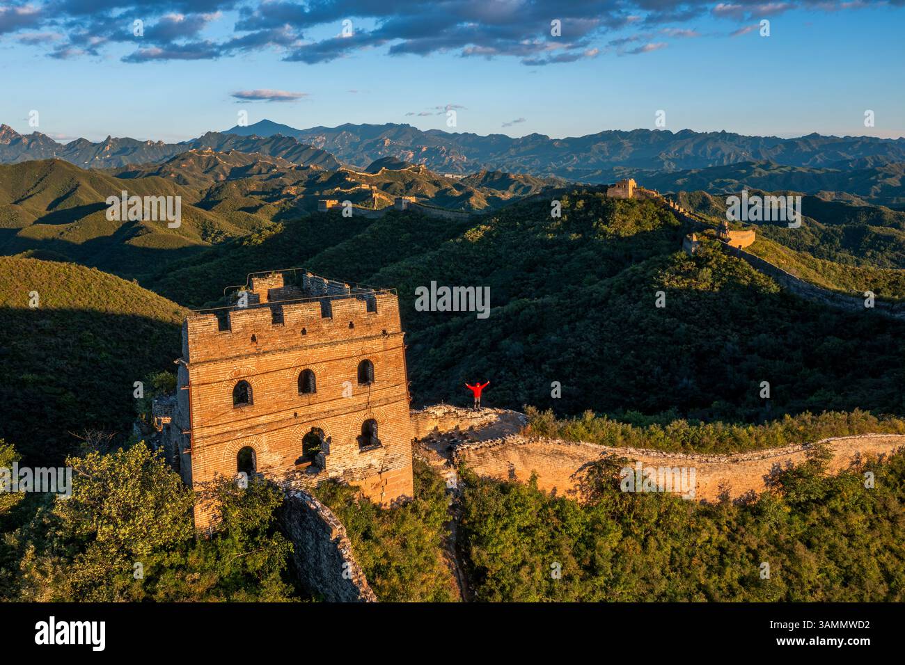 Aerial view of the historic Jinshanling old Great Wall amidst rugged mountains and a scenic sky, Chengde, China. Stock Photo