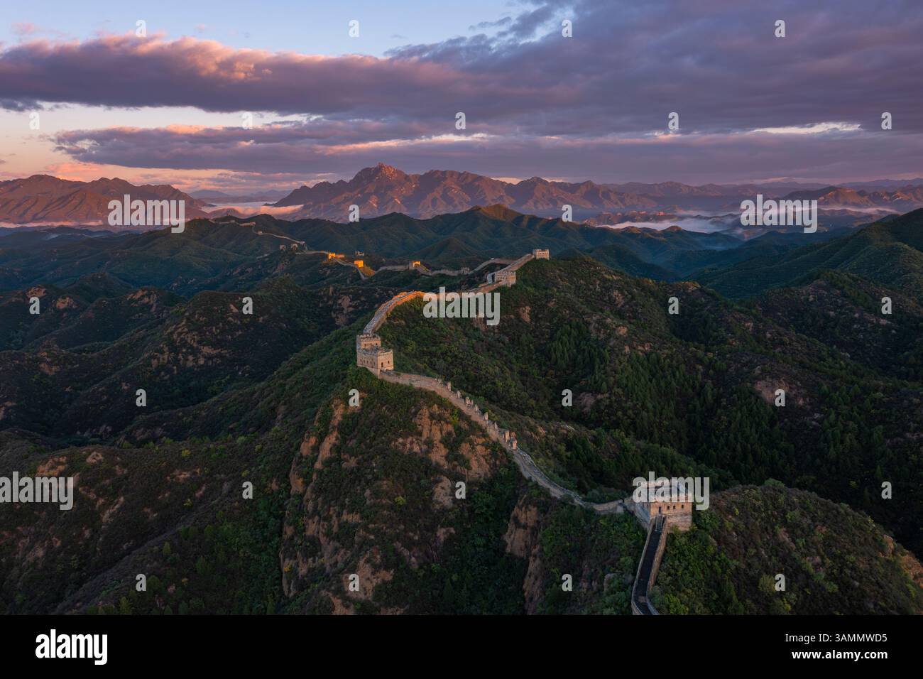 Aerial view of the majestic Jinshanling Great Wall surrounded by mountains at sunset, Chengde, China. Stock Photo