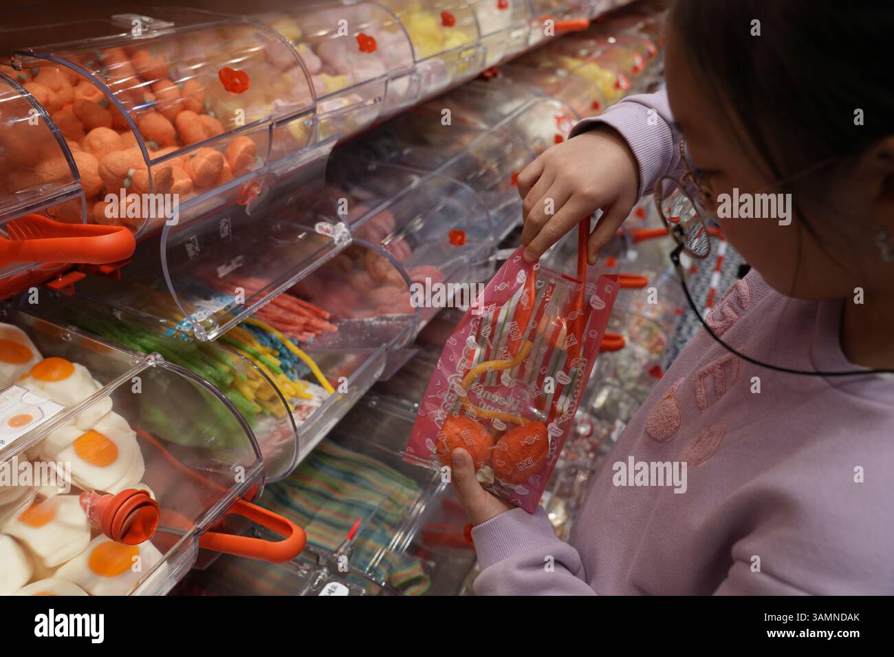 Girl puts sweets in hi-res stock photography and images - Alamy