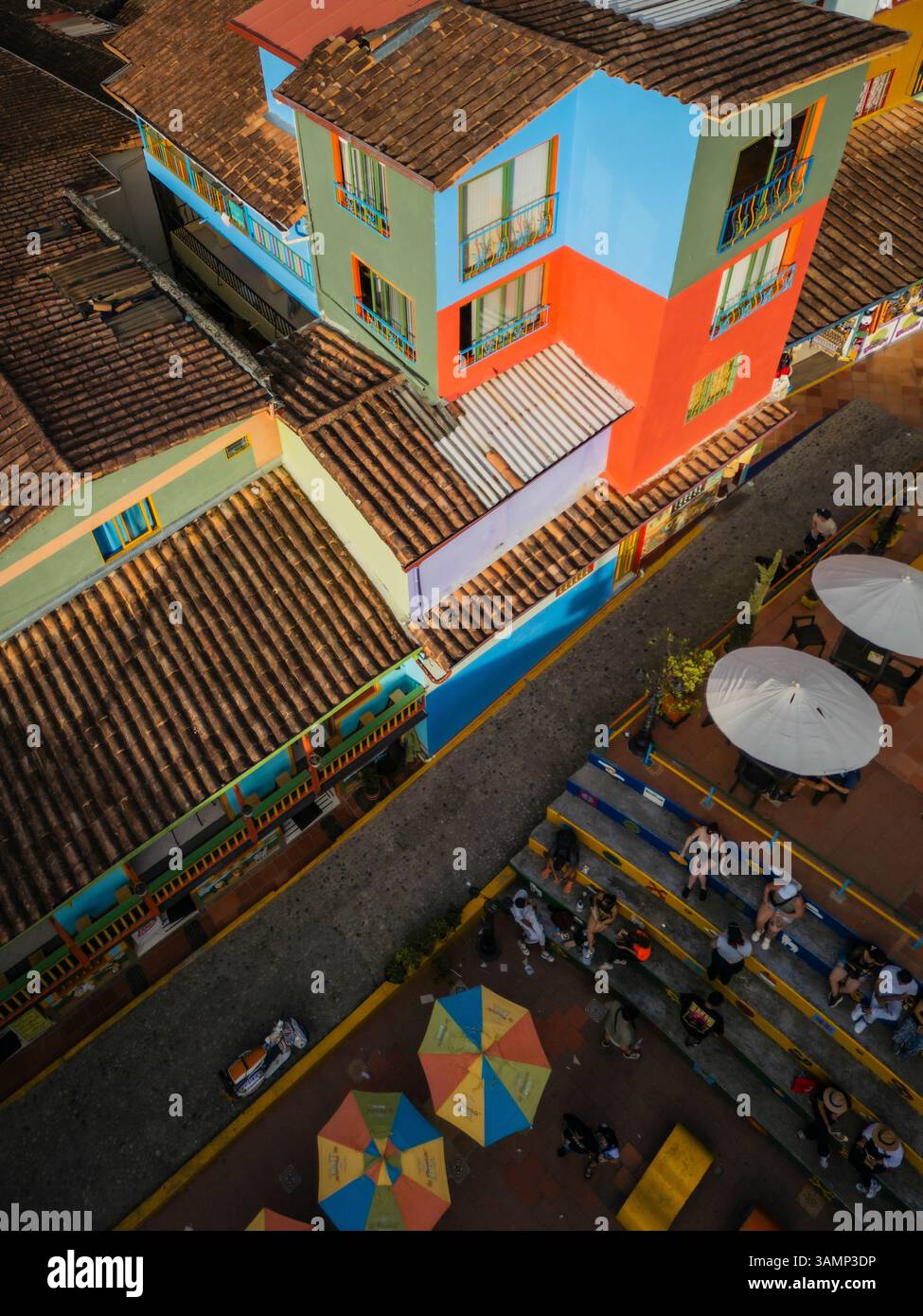 Aerial view of colorful buildings, rooftops, and street with people and ...