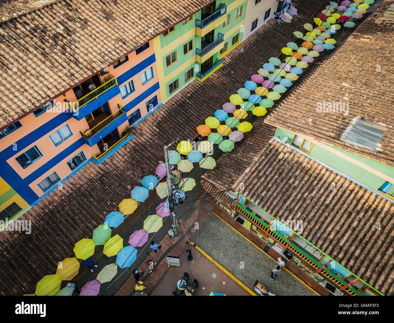 Aerial view of colorful umbrellas and vibrant rooftops in Guatape ...