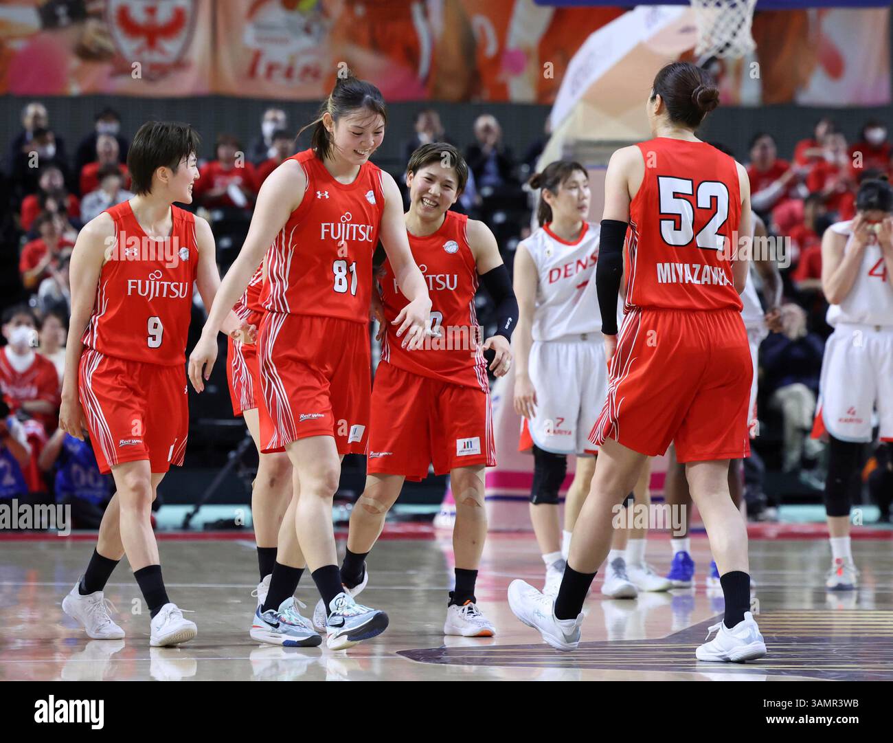 Members of Fujitsu celebrate after winning the women's basketball W ...