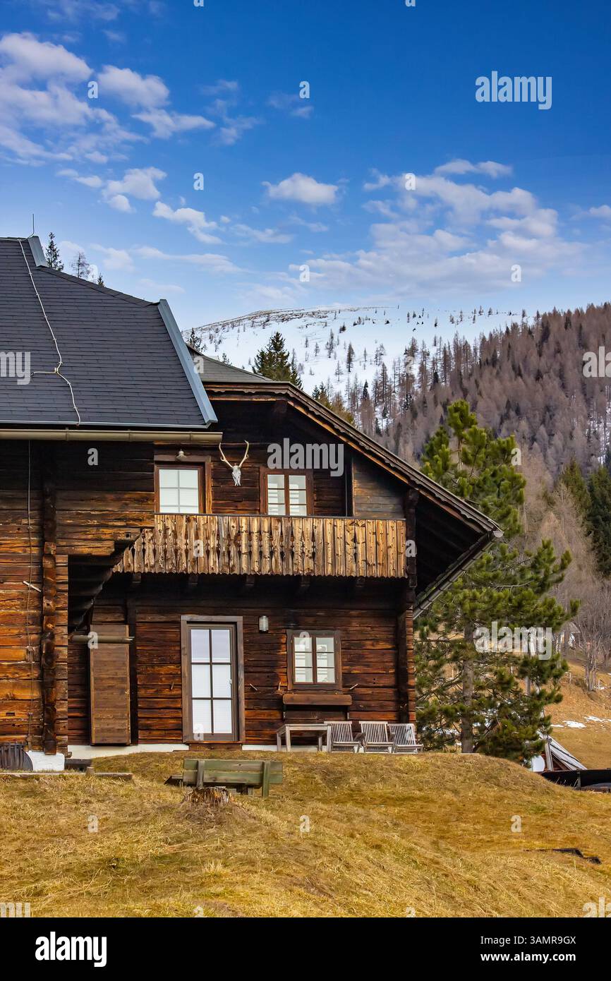 Rustic Cabin in Snowy Alpine Mountain Landscape Stock Photo