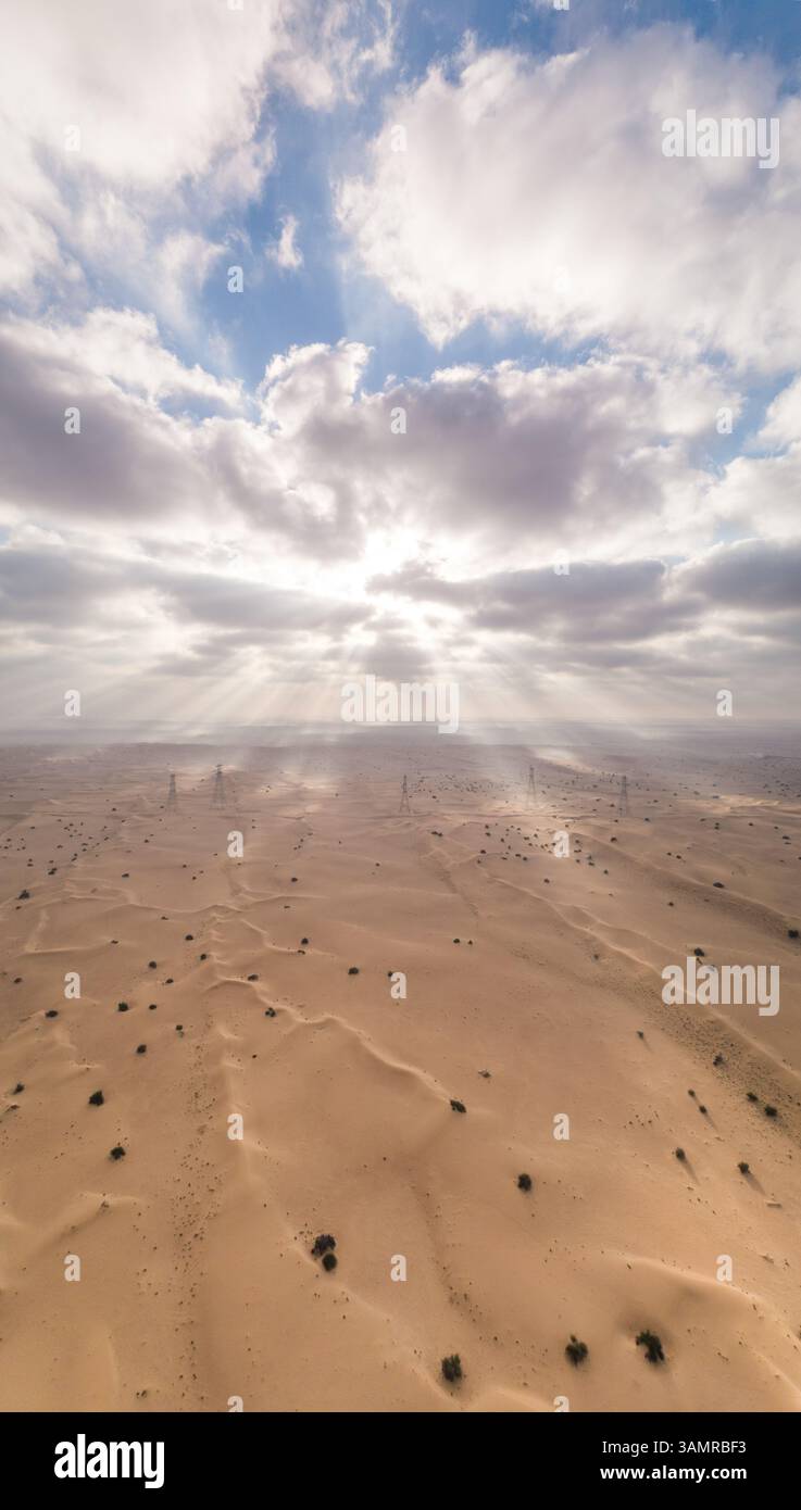 Aerial view of sunlight and clouds above desert and dunes in Dubai, UAE ...