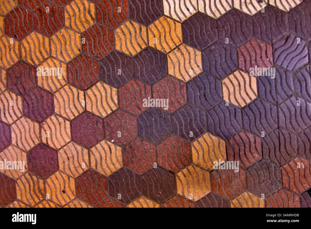 Pedestrian walkway tiles in Valencia, Spain feature a hexagonal pattern with a textured surface Stock Photo