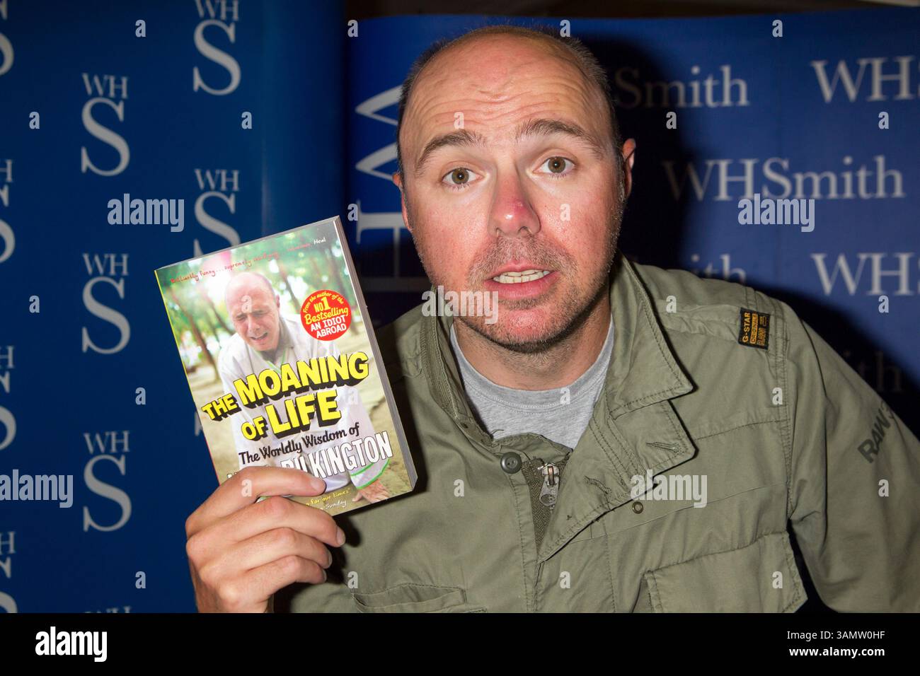 Karl Pilkington signs his book 
