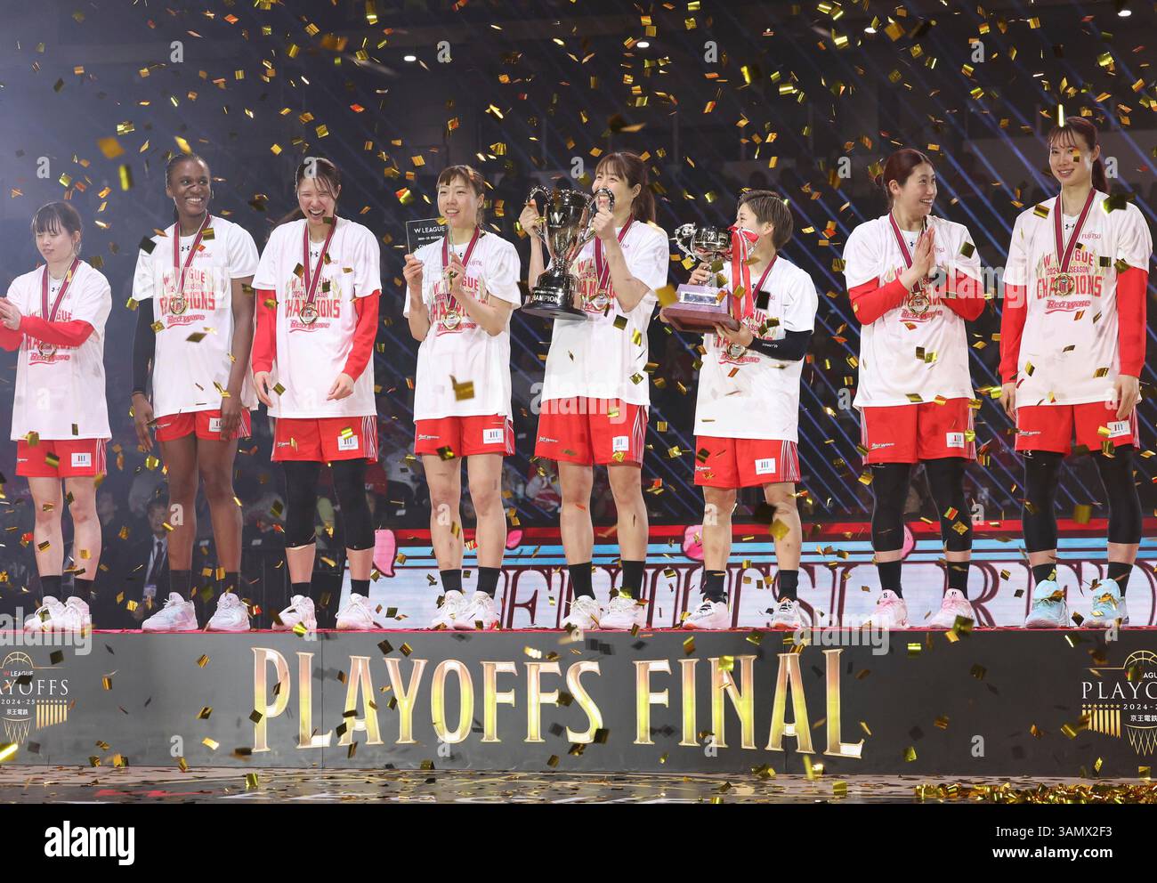 Members of Fujitsu celebrate after winning the women's basketball W ...