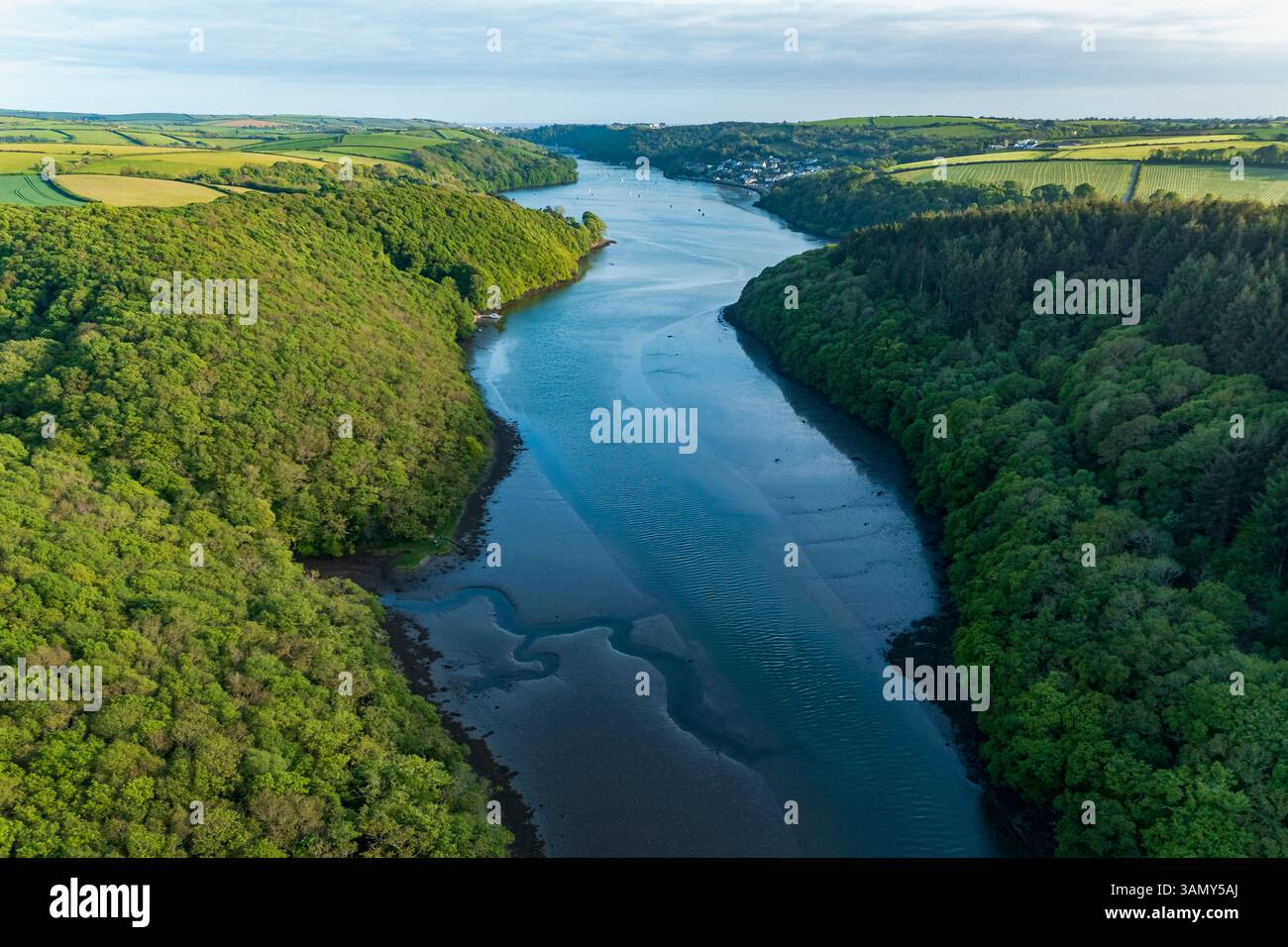 Aerial view looking down the river Lerryn above the treetops at sunset, Lostwithiel, Lerryn, Cornwall, United Kingdom. Stock Photo