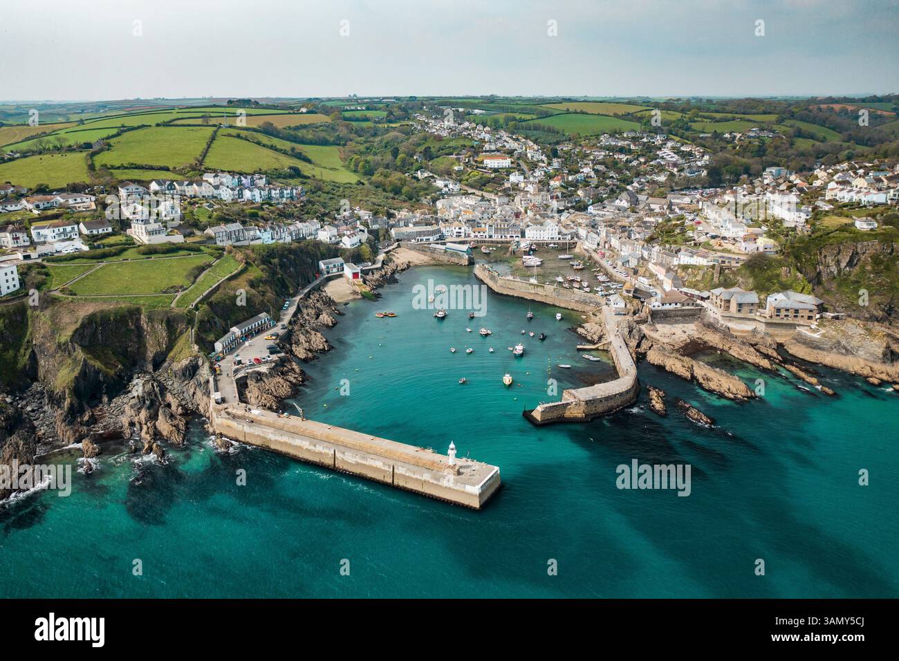 Aerial view of Mevagissey Harbour at low tide with fishing boats