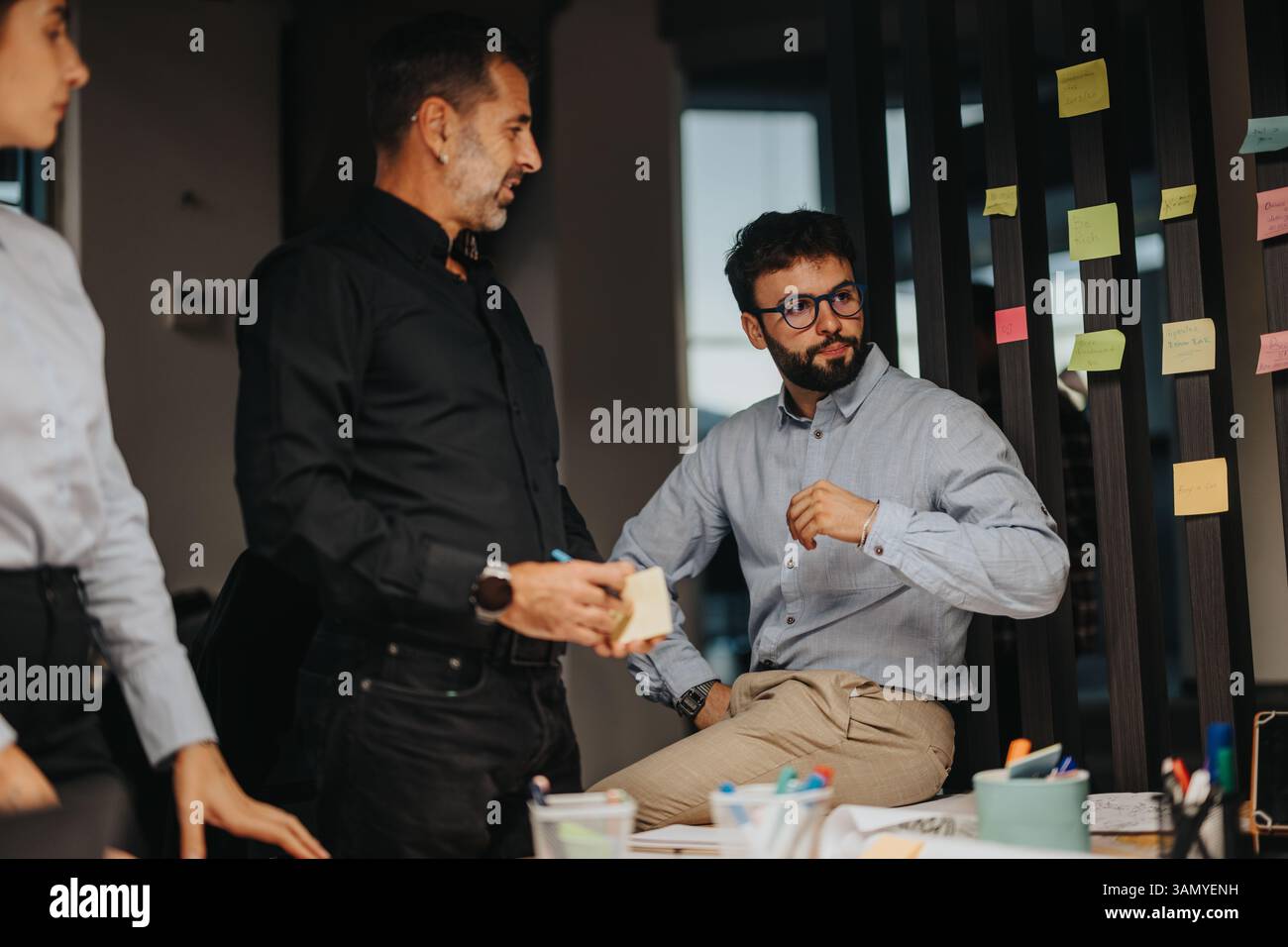 Business professionals engaging in a creative brainstorming session with sticky notes Stock Photo