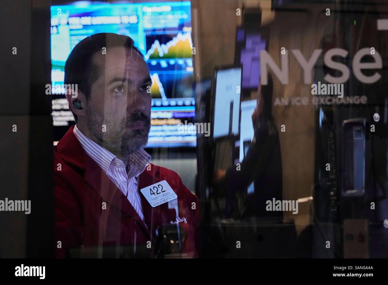 Trader Robert Greason works on the floor of the New York Stock Exchange ...