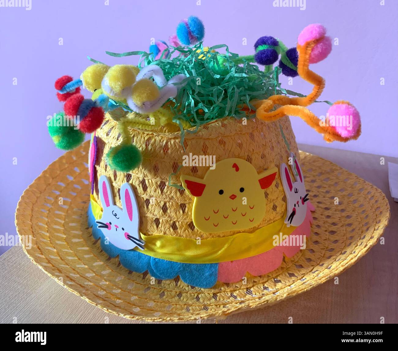 Hat easter bonnet yellow hat colour coloured big brim eggs chicks chicken chickens nice top hat straw design designed green yellow blue red pink - Smartphone Captured Stock Image