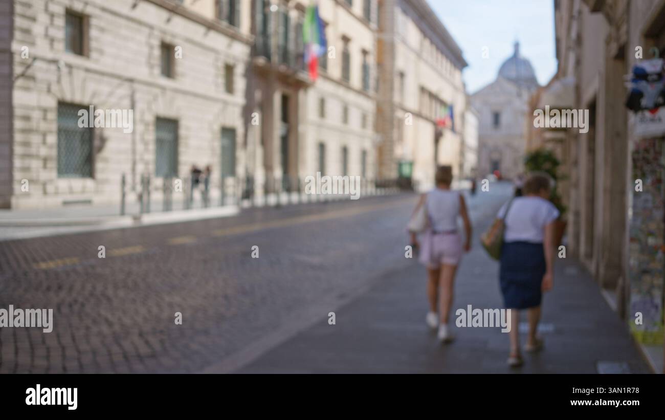 Women walking on a defocused, cobblestone street in rome with blurred ...