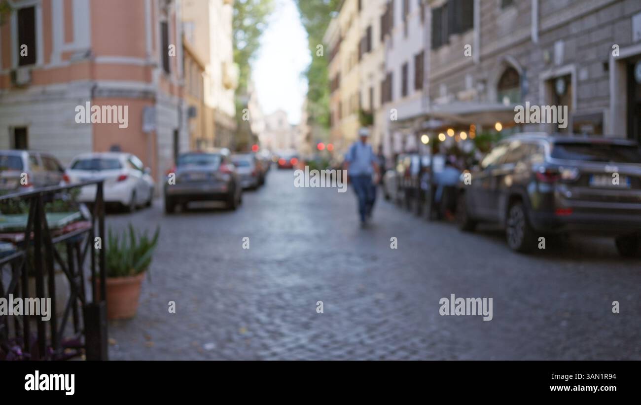 Blurred street scene in rome, italy with defocused people and cars ...