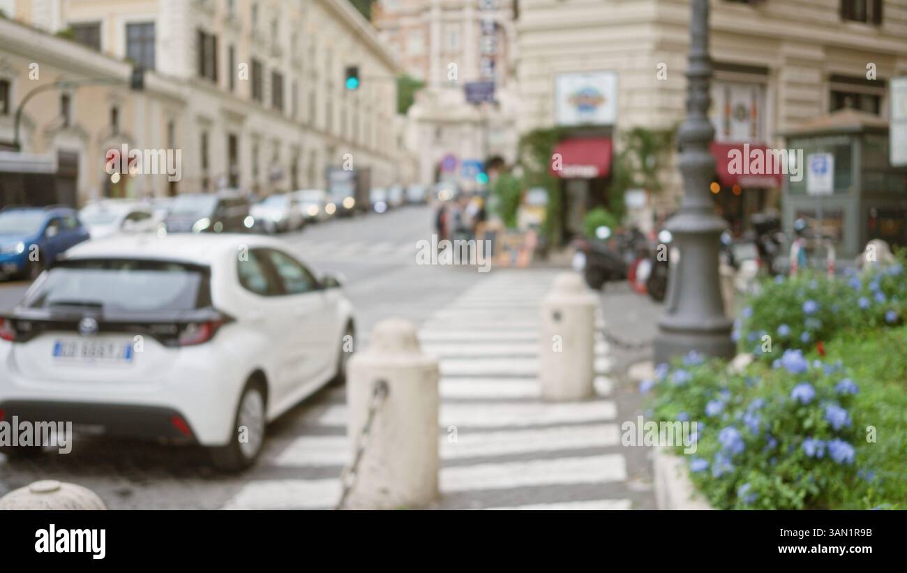Blurred street scene in rome at night features defocused lights and ...