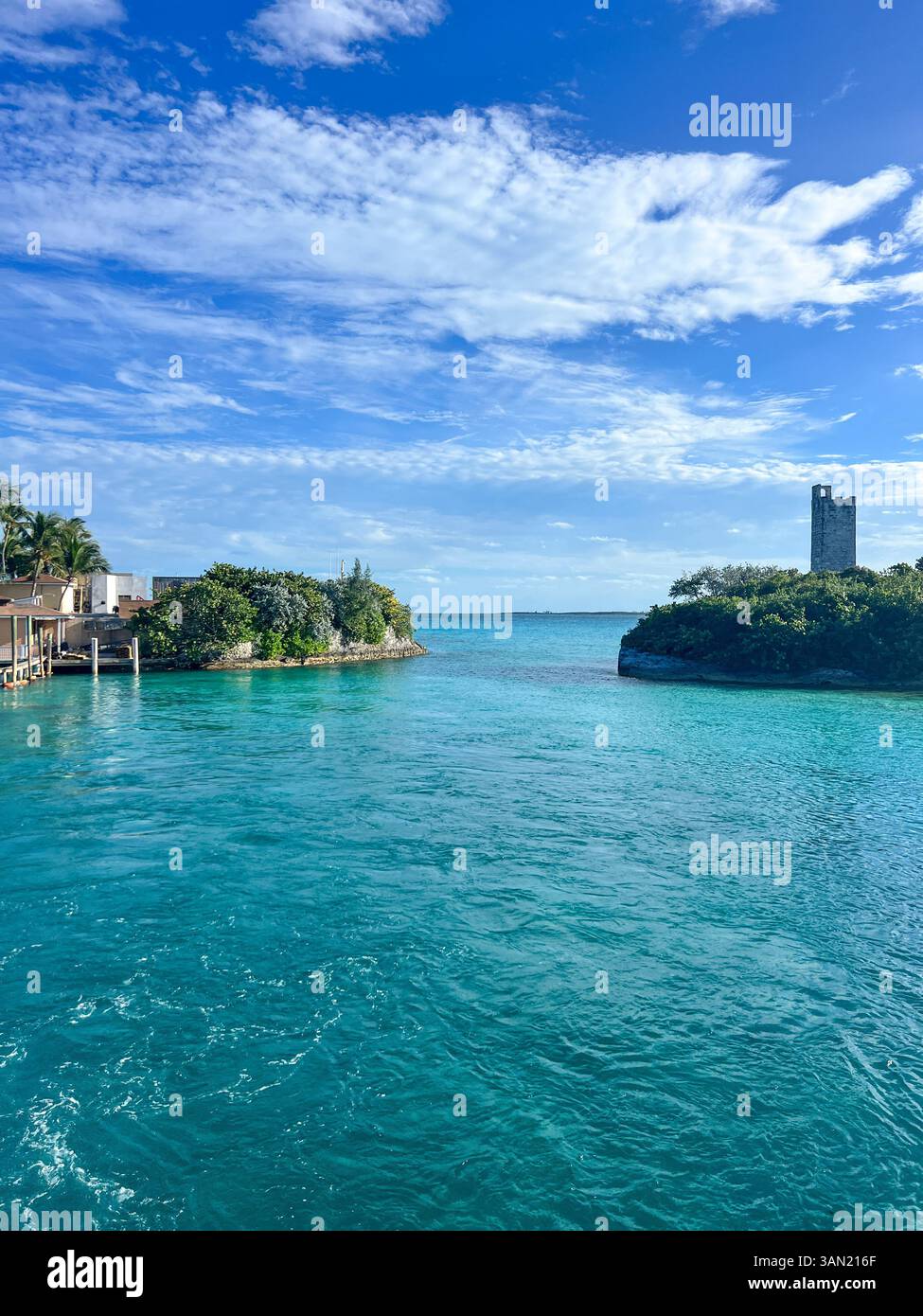 A breathtaking view of Blue Lagoon Island, where crystal-clear waters meet lush greenery and historic landmarks. A perfect destination for relaxation - Smartphone Captured Stock Image
