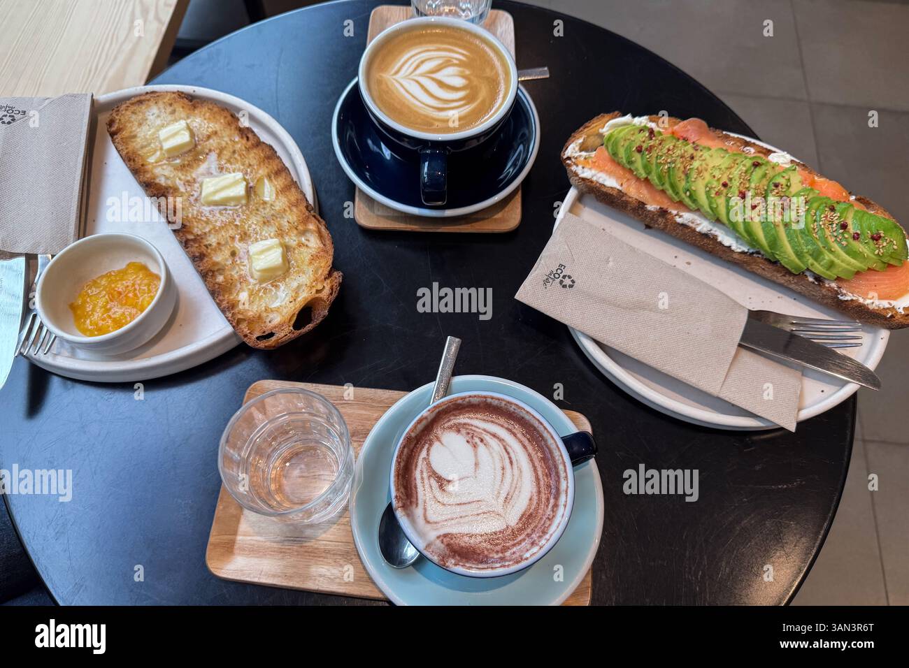Varied breakfast with toasts, chocolate and coffee on restaurant table Stock Photo