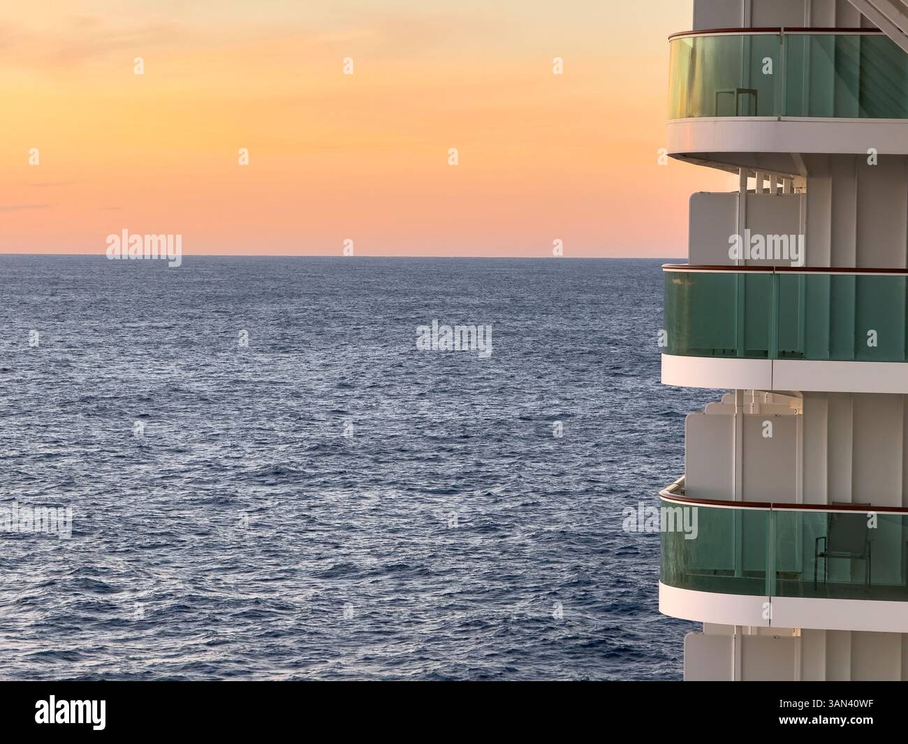 Cruise ship balconies at sea with horizon, ocean and sky at sunset - Smartphone Captured Stock Image