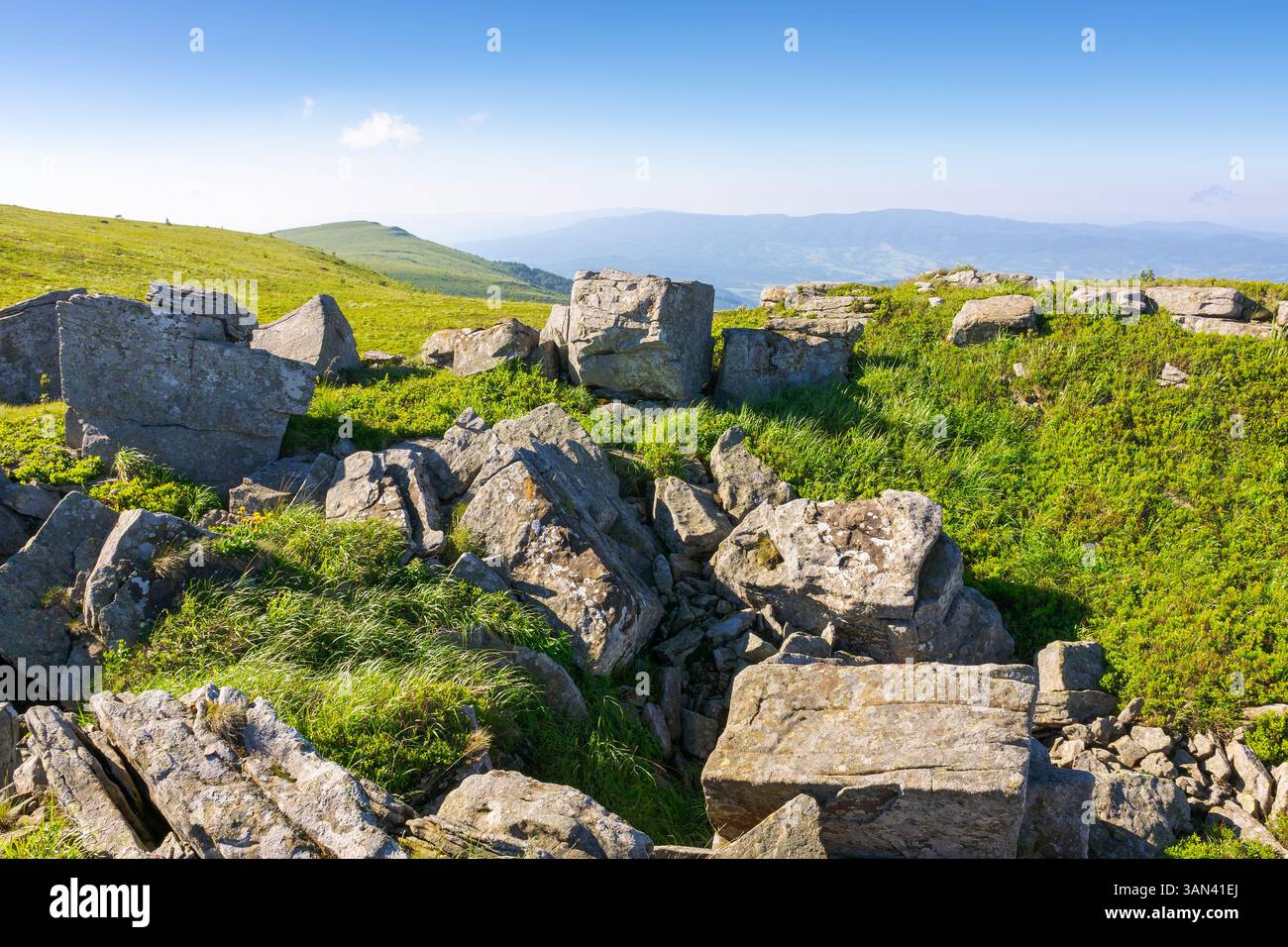 white sharp stones on the hillside. lovely carpathian mountain landscape in summer. vacation season background. huge rocks scattered among alpine gras Stock Photo