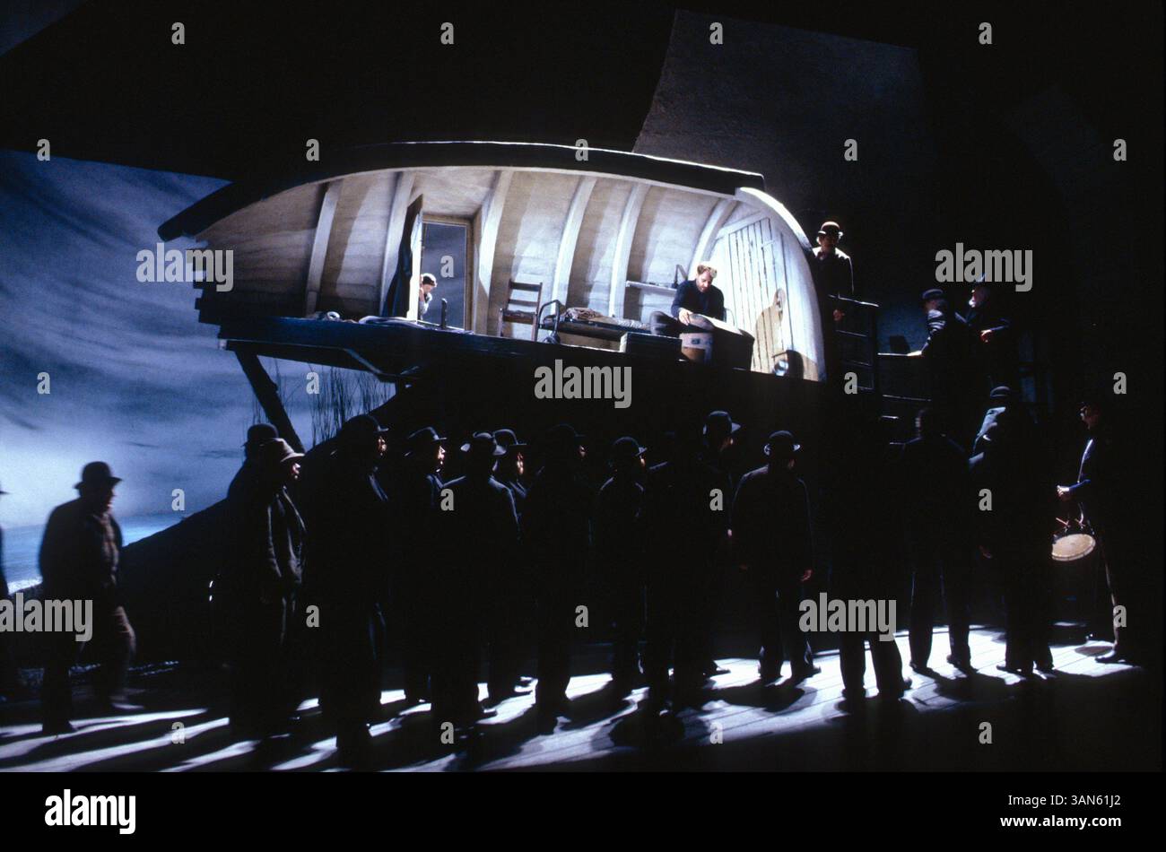 townsfolk arrive at Grimes's hut as the apprentice exits: Stephan Drakulich (Peter Grimes) in PETER GRIMES at Glyndebourne Festival Opera, East Sussex, England  02/05/1992 music: Benjamin Britten  libretto: Montagu Slater  conductor: Andrew Davis  design: John Gunter  lighting: Pat Collins  director: Trevor Nunn Stock Photo